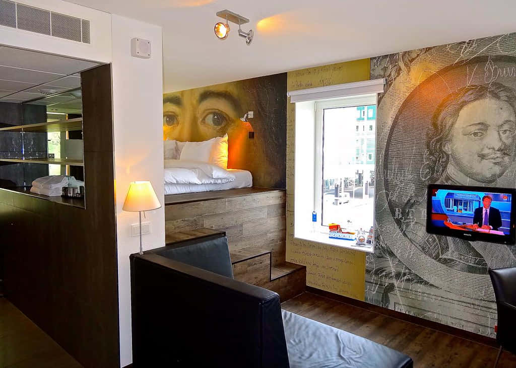 Inntel Hotel Zaandam, bed raised on a wooden platform, walls adorned with large artistic portraits, SD Desktop Wallpaper