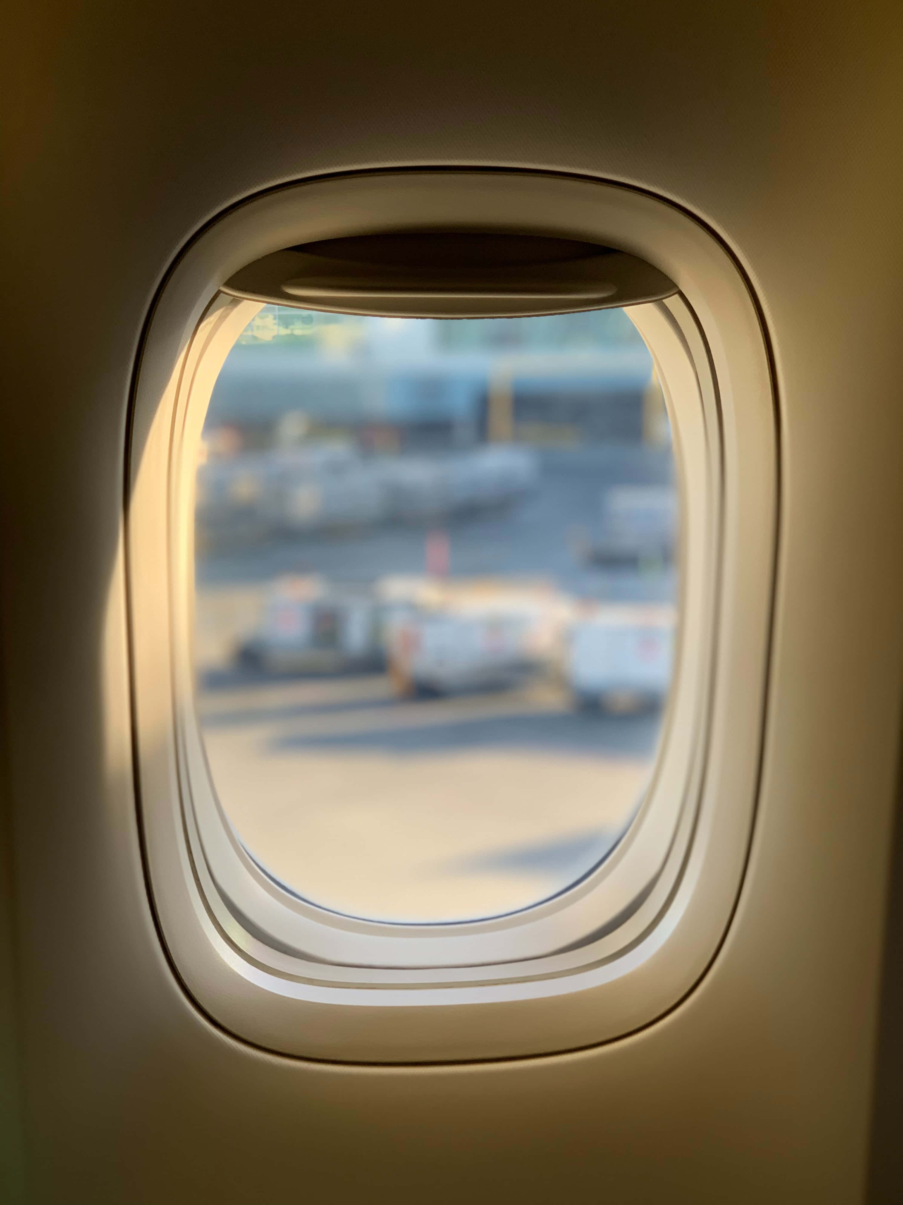 airplane window, warm sunlight, airport tarmac, 4K Phone Wallpaper
