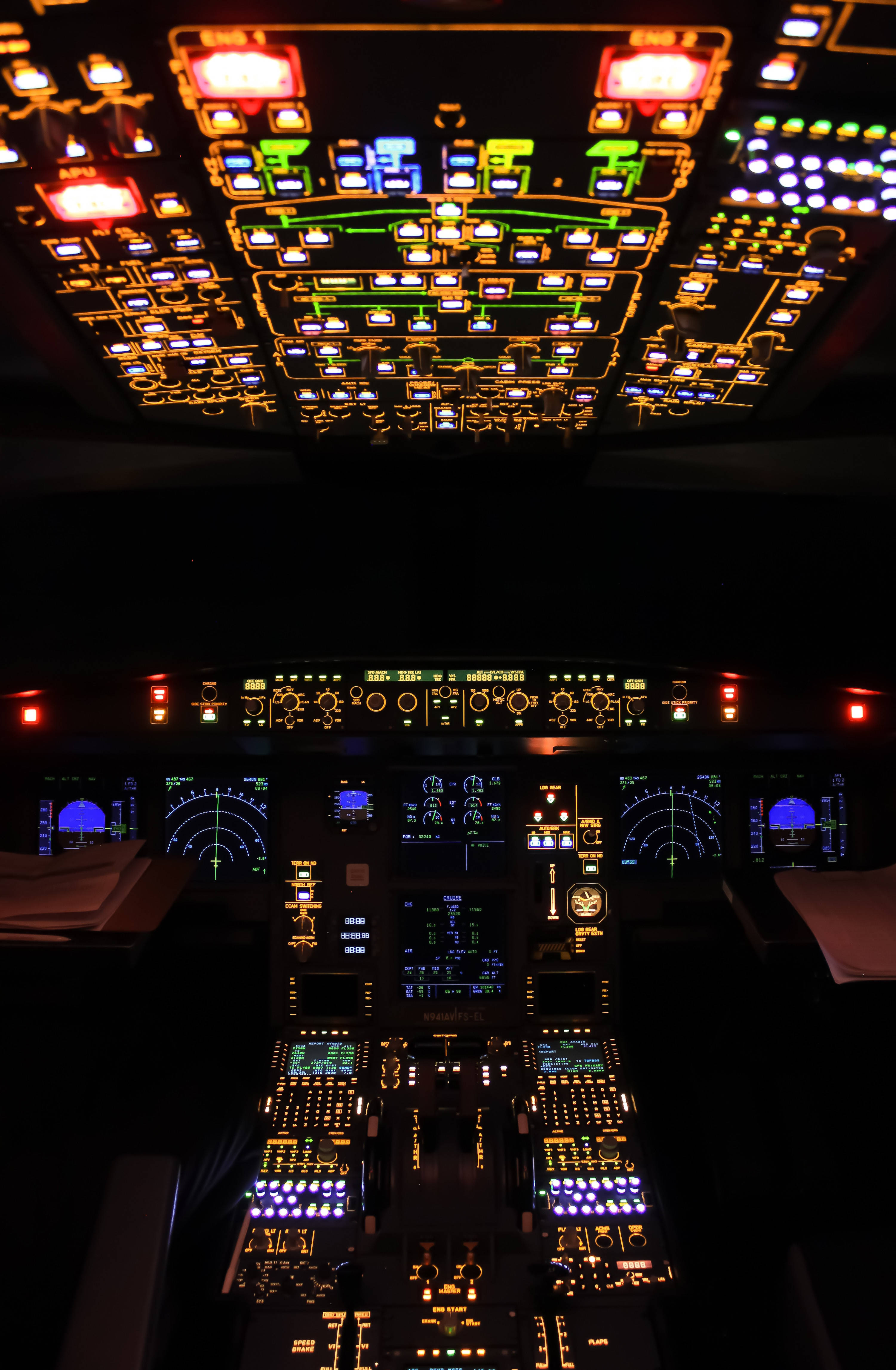 Modern Digital Airplane Cockpit, glowing multicolored instrument panels, overhead lights, 4K Phone Wallpaper