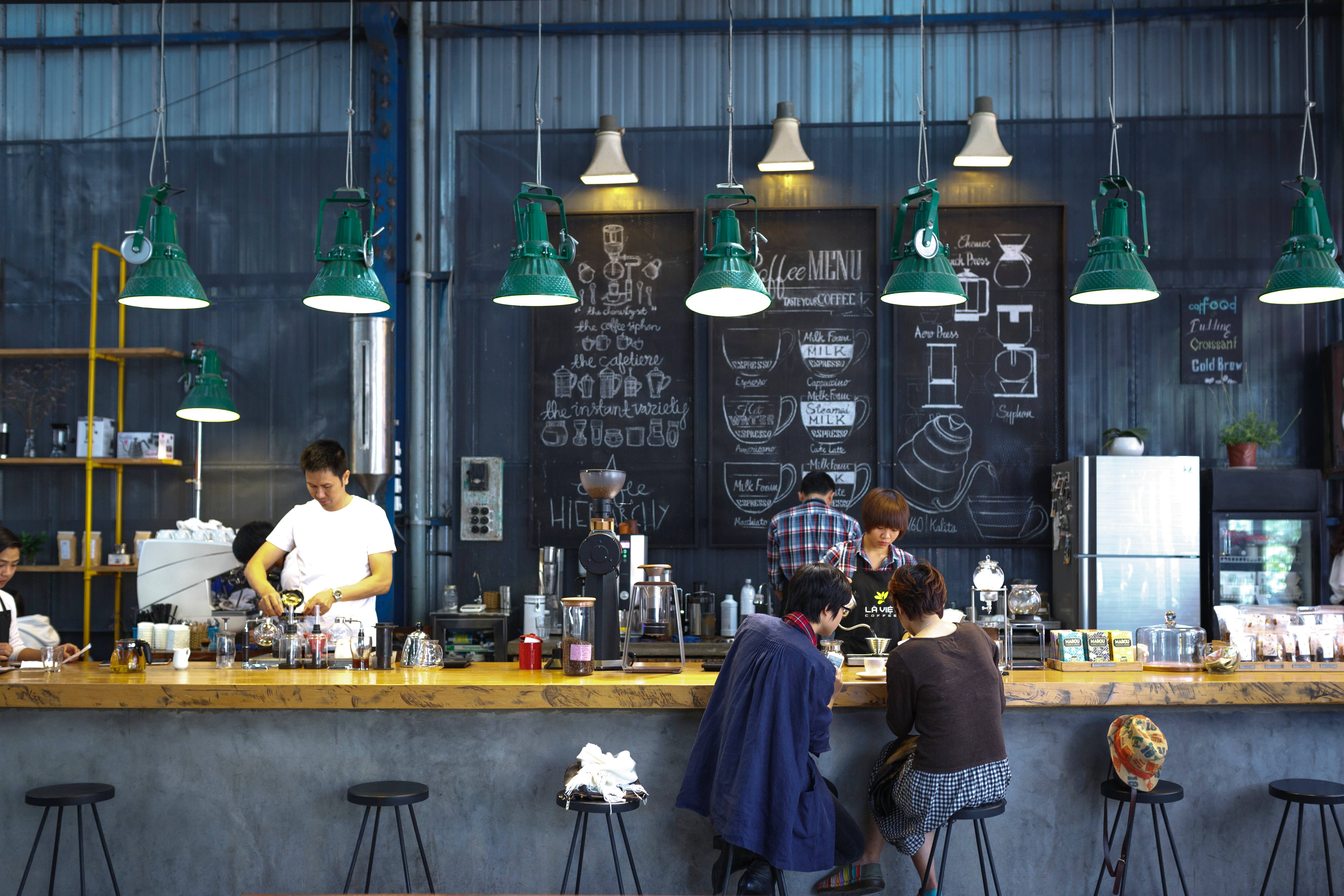 industrial-style coffee shop, green pendant lights, chalkboard menus, 5K Desktop Wallpaper