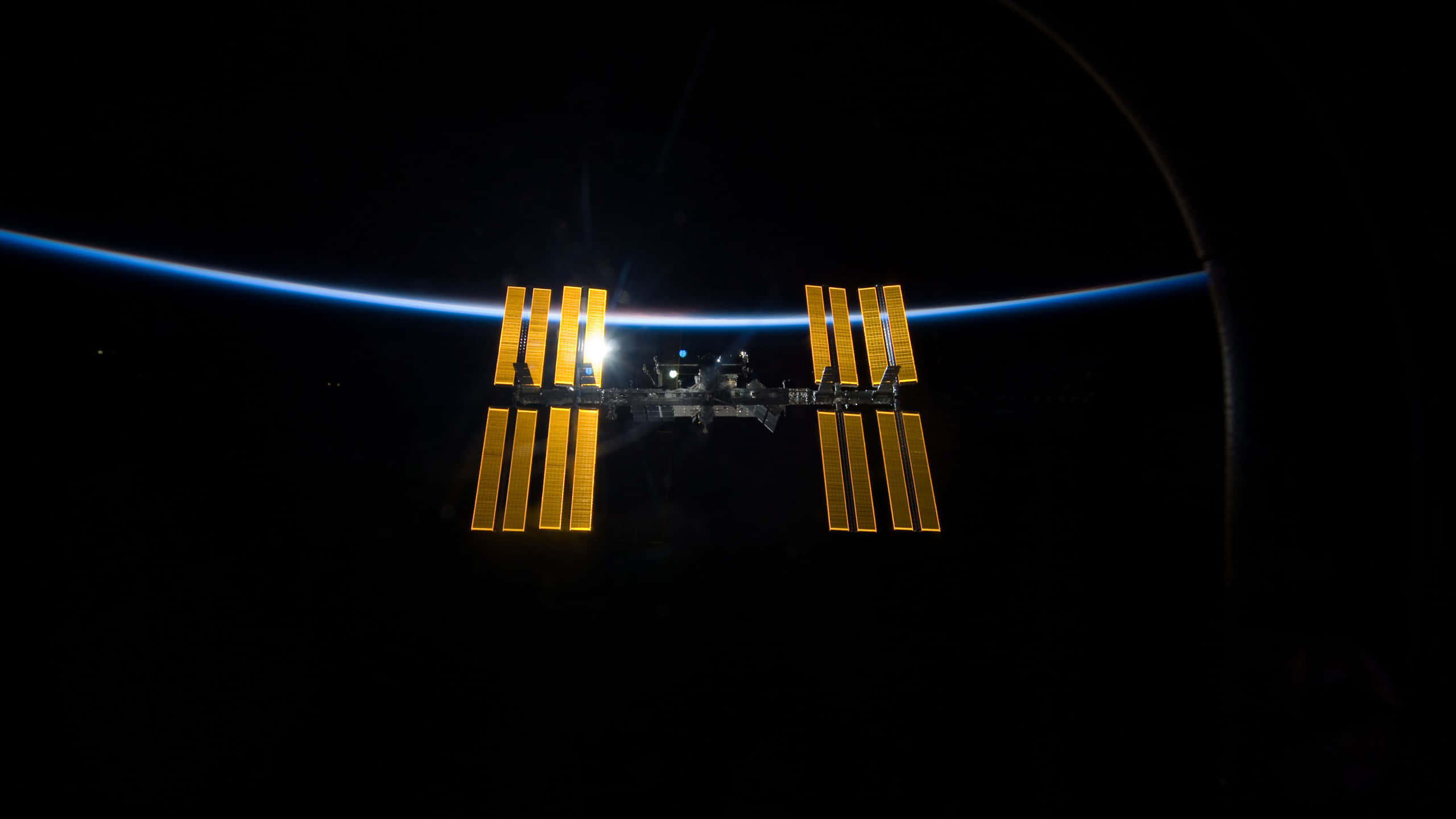 International Space Station, golden solar arrays, black void, 2K Desktop Wallpaper