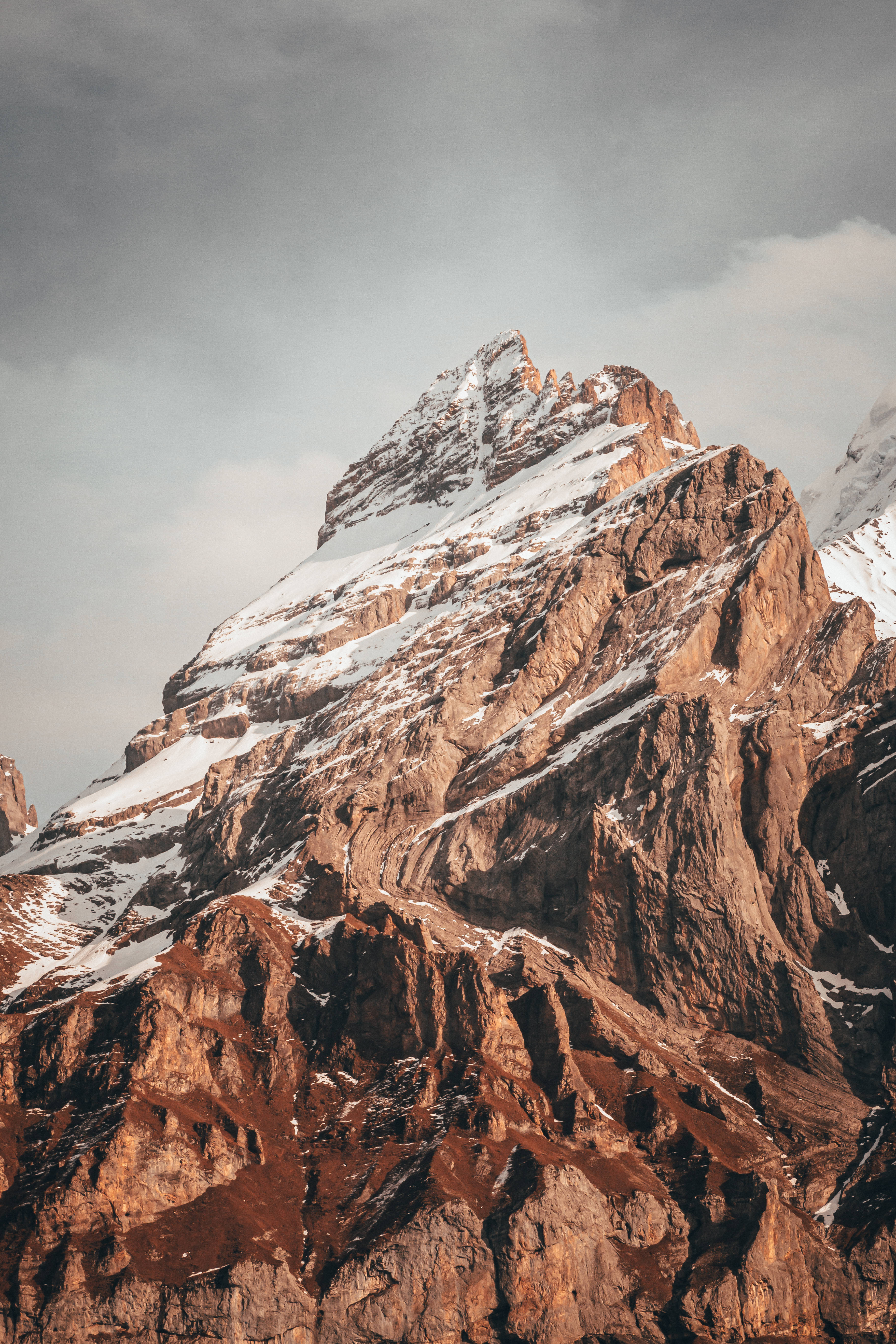 tall rocky mountain, snow-capped mountain peak, rugged brown rock faces, 5K Phone Wallpaper