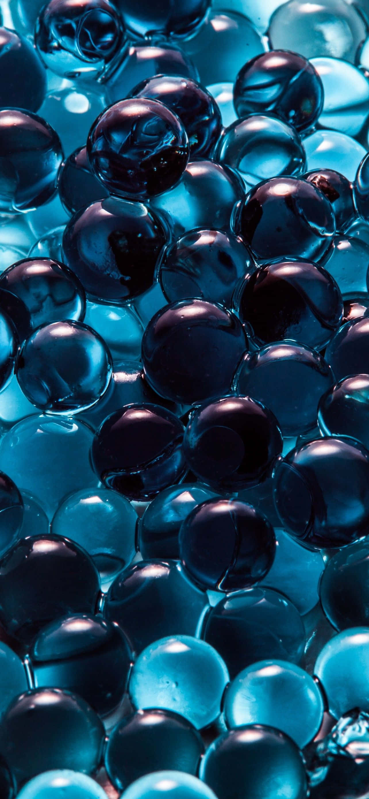 iPhone 14 Plus, glossy blue gel beads, cyan highlights, 2K Phone Wallpaper