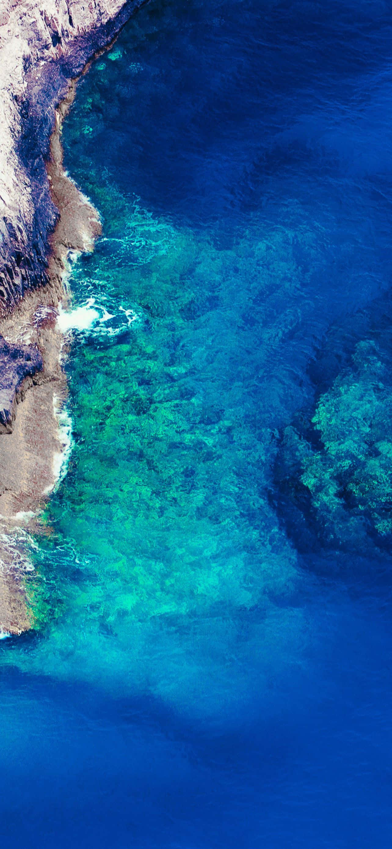iPhone 14 Plus, turquoise waters, rugged cliffs, 2K Phone Wallpaper