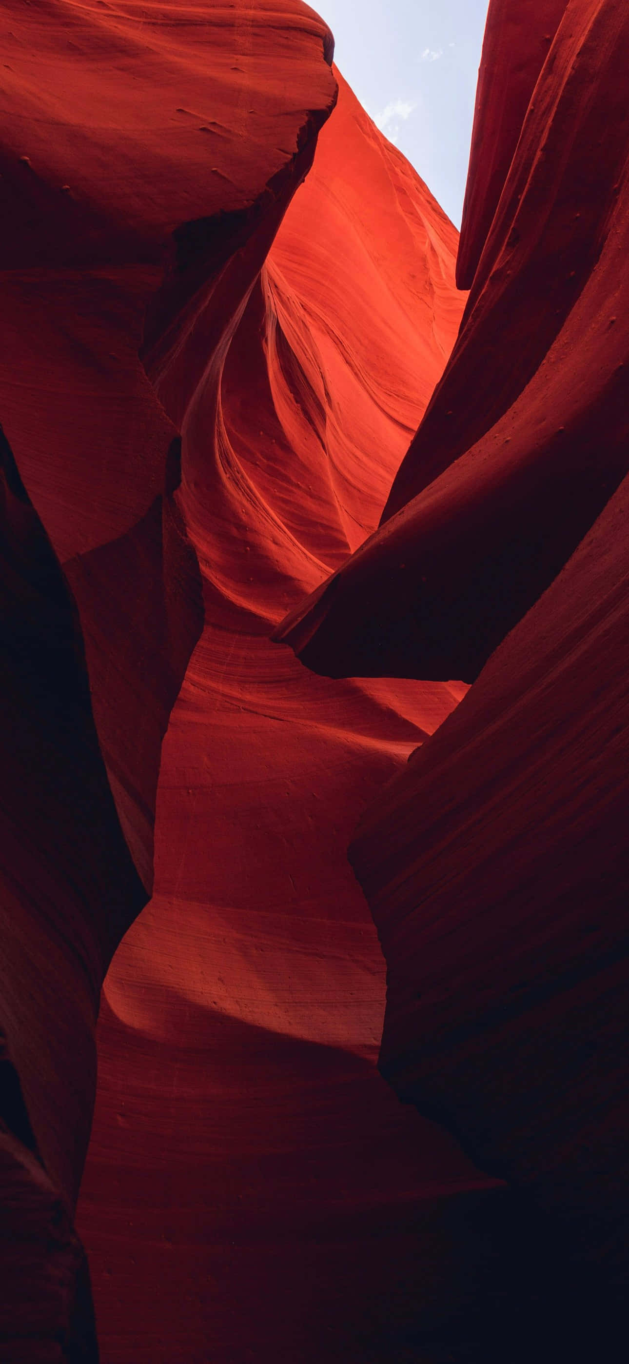 iPhone 16 Plus, sunlight, swirling red sandstone walls, 2K Phone Wallpaper