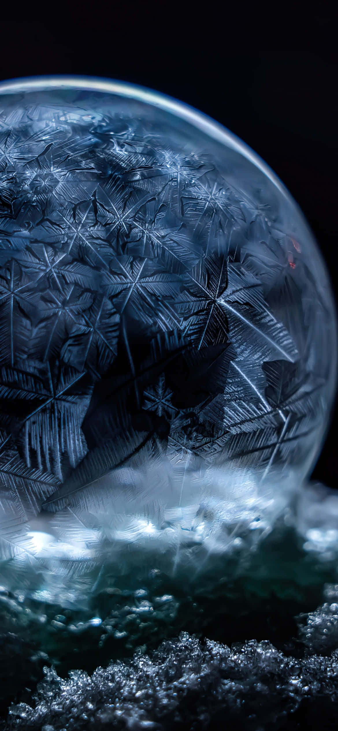 iPhone 16e, frost-covered glass sphere, snowy ground, Full HD Phone Wallpaper