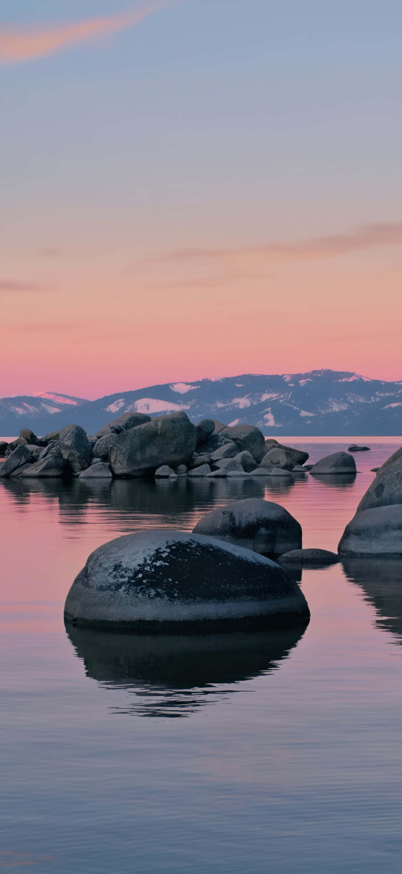 iPhone 17 Pro Max, pink and blue sunset, calm water, 2K Phone Wallpaper