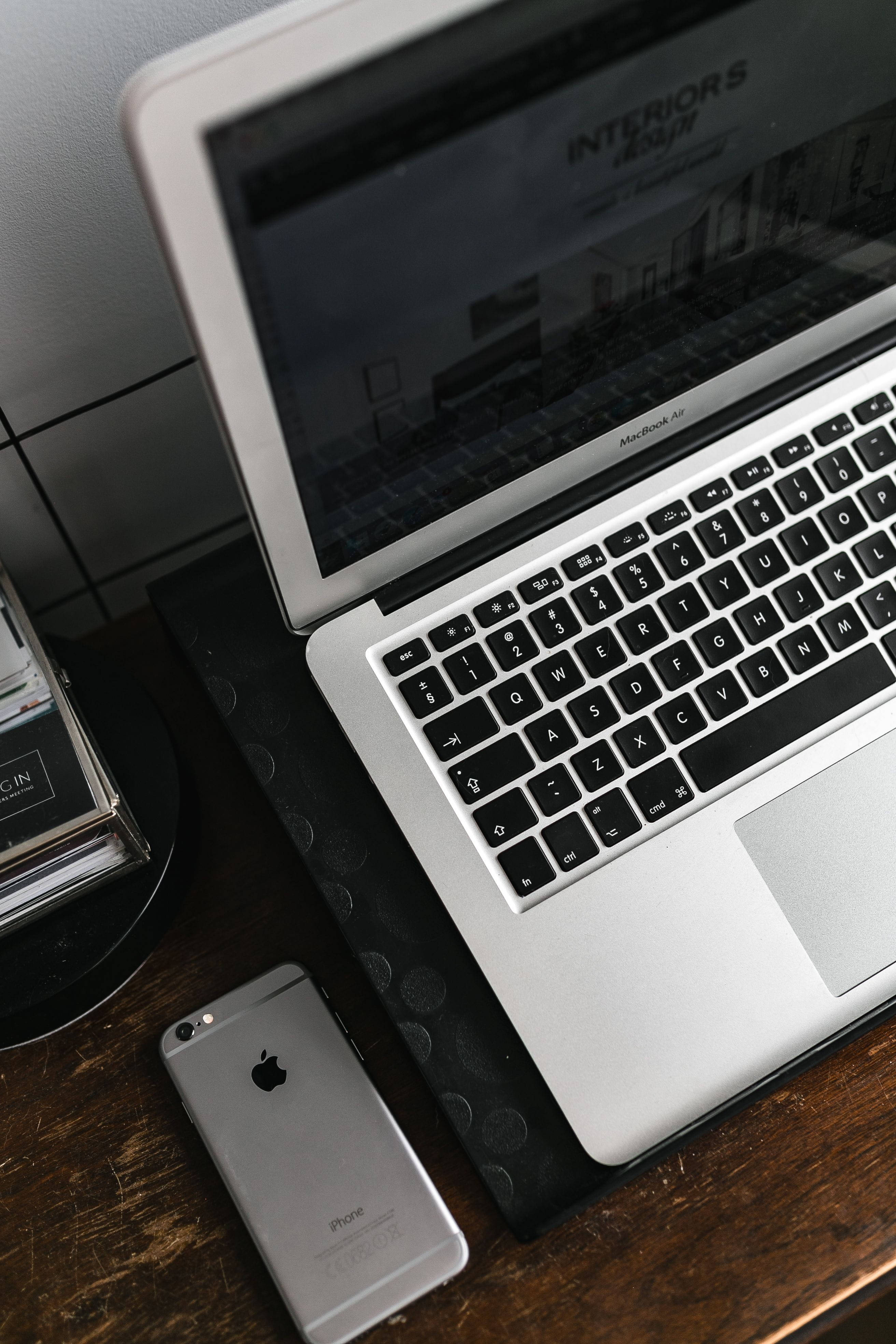 iPhone Desk, silver MacBook Air, dark wooden desk, 4K Phone Wallpaper