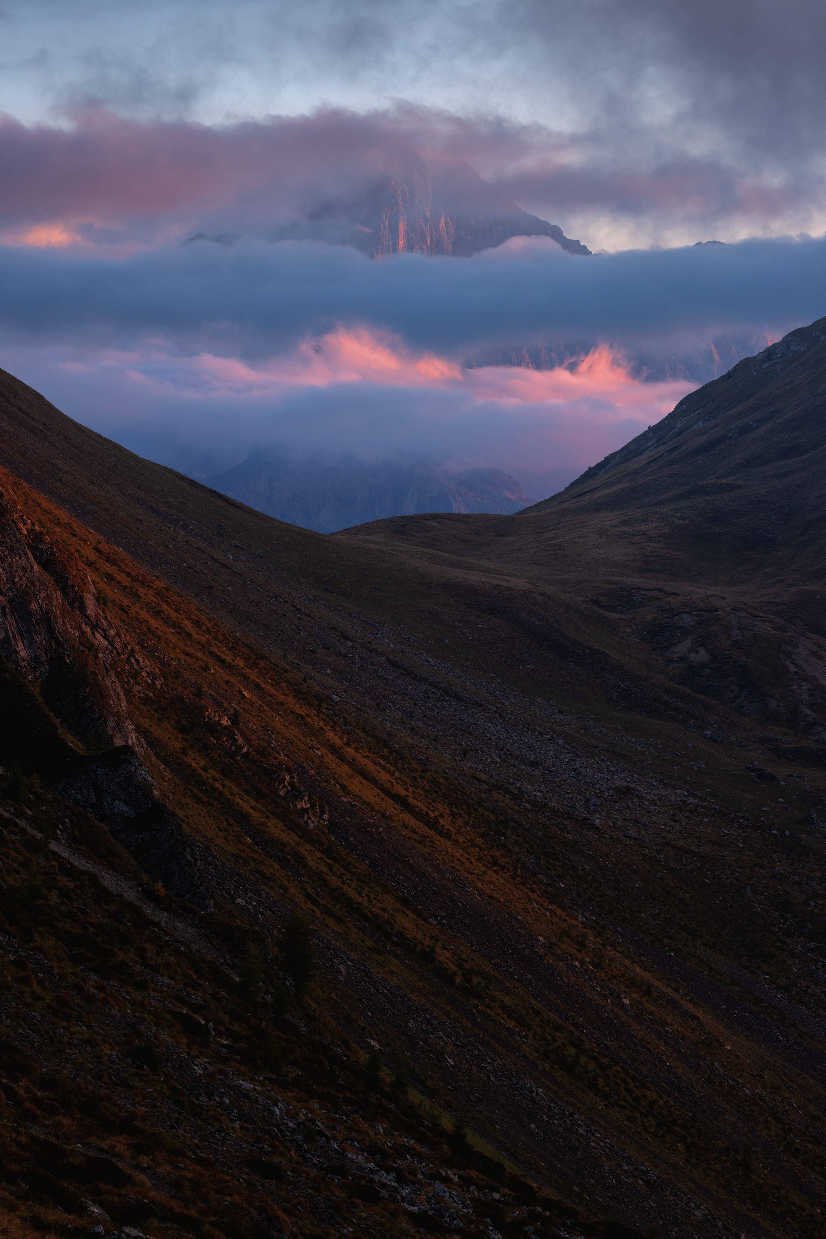 steep mountain slope, pink and purple clouds, dusk, 4K Phone Wallpaper
