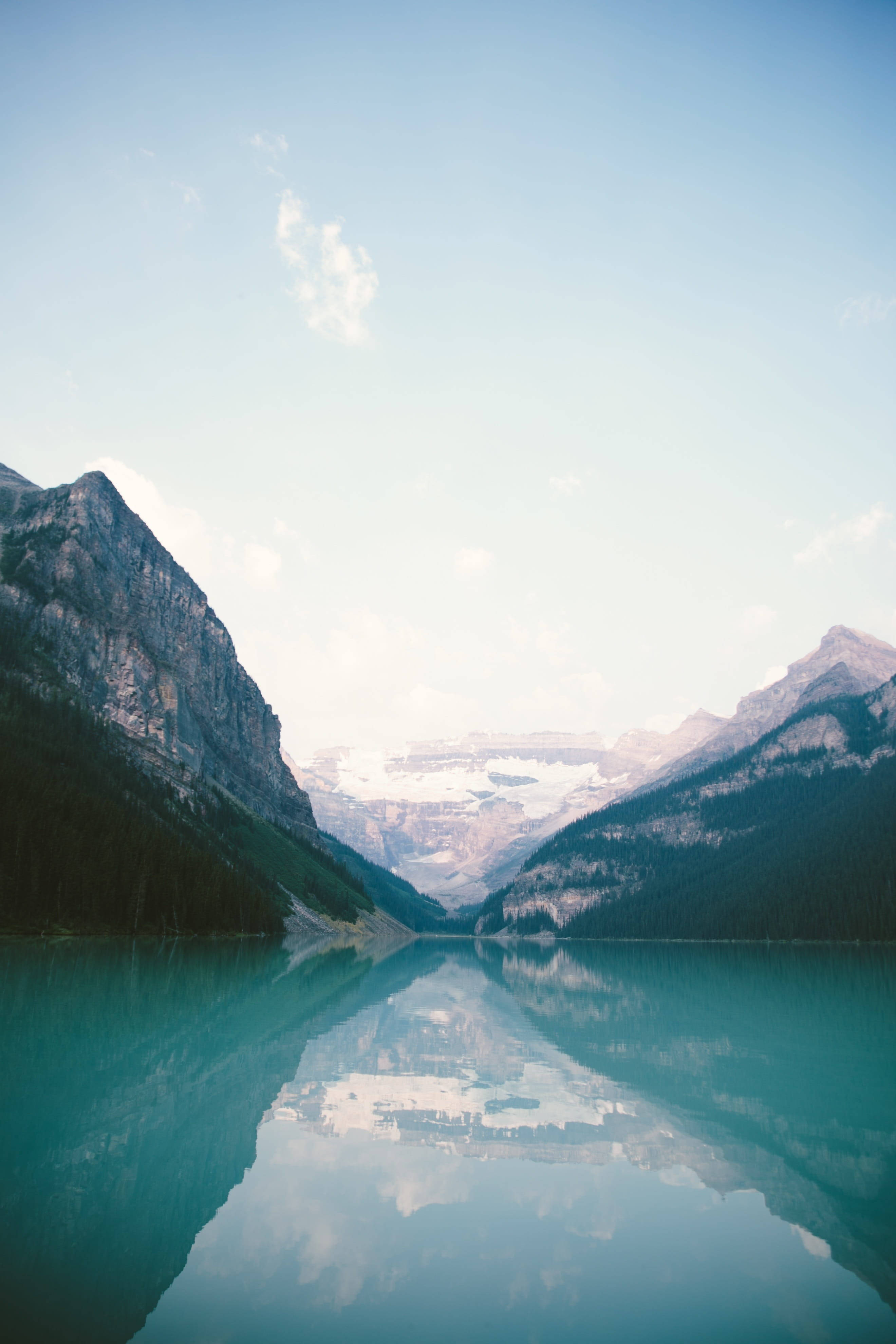 mountain lake, snow-capped peaks, soft blue sky, 4K Phone Wallpaper