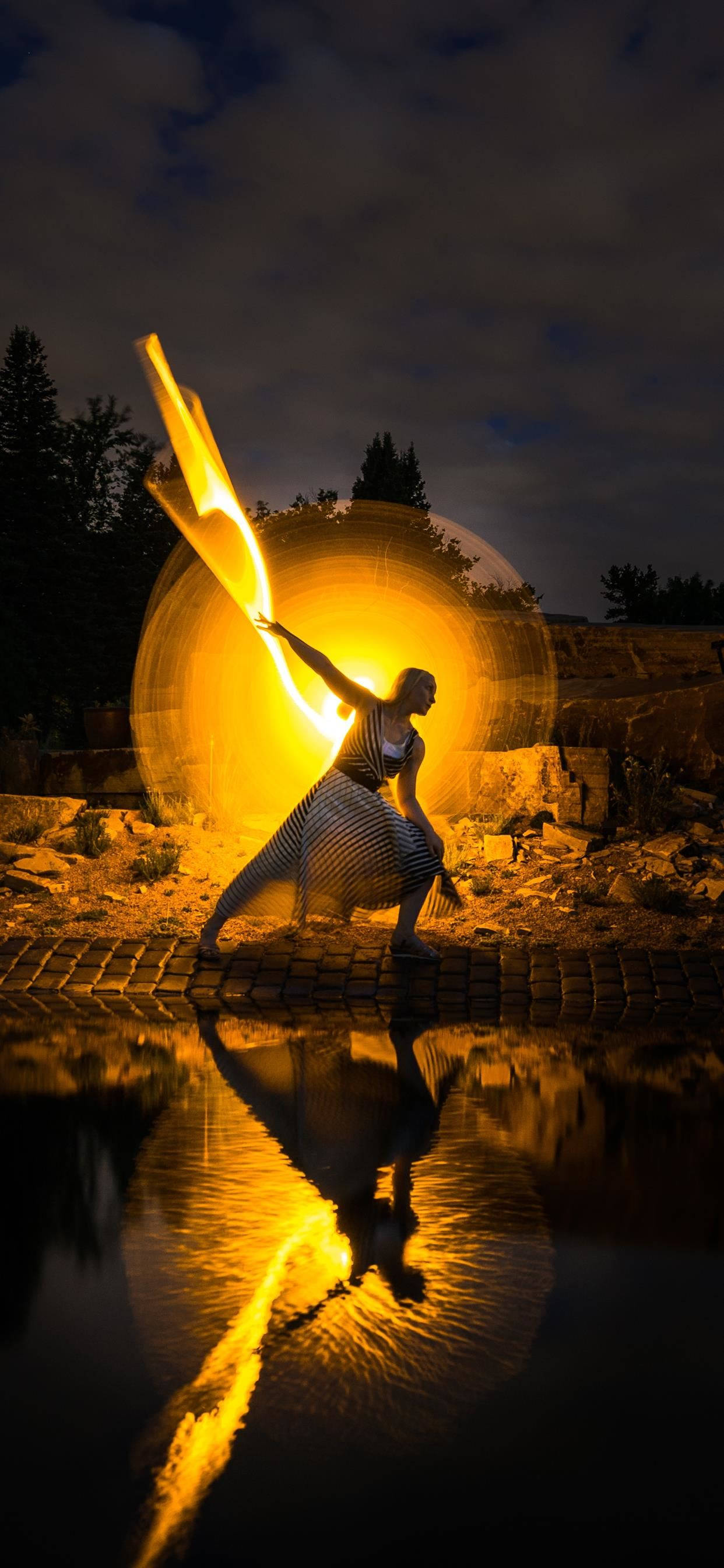 iPhone SE 2020, dancer, glowing fire staff, 2K Phone Wallpaper