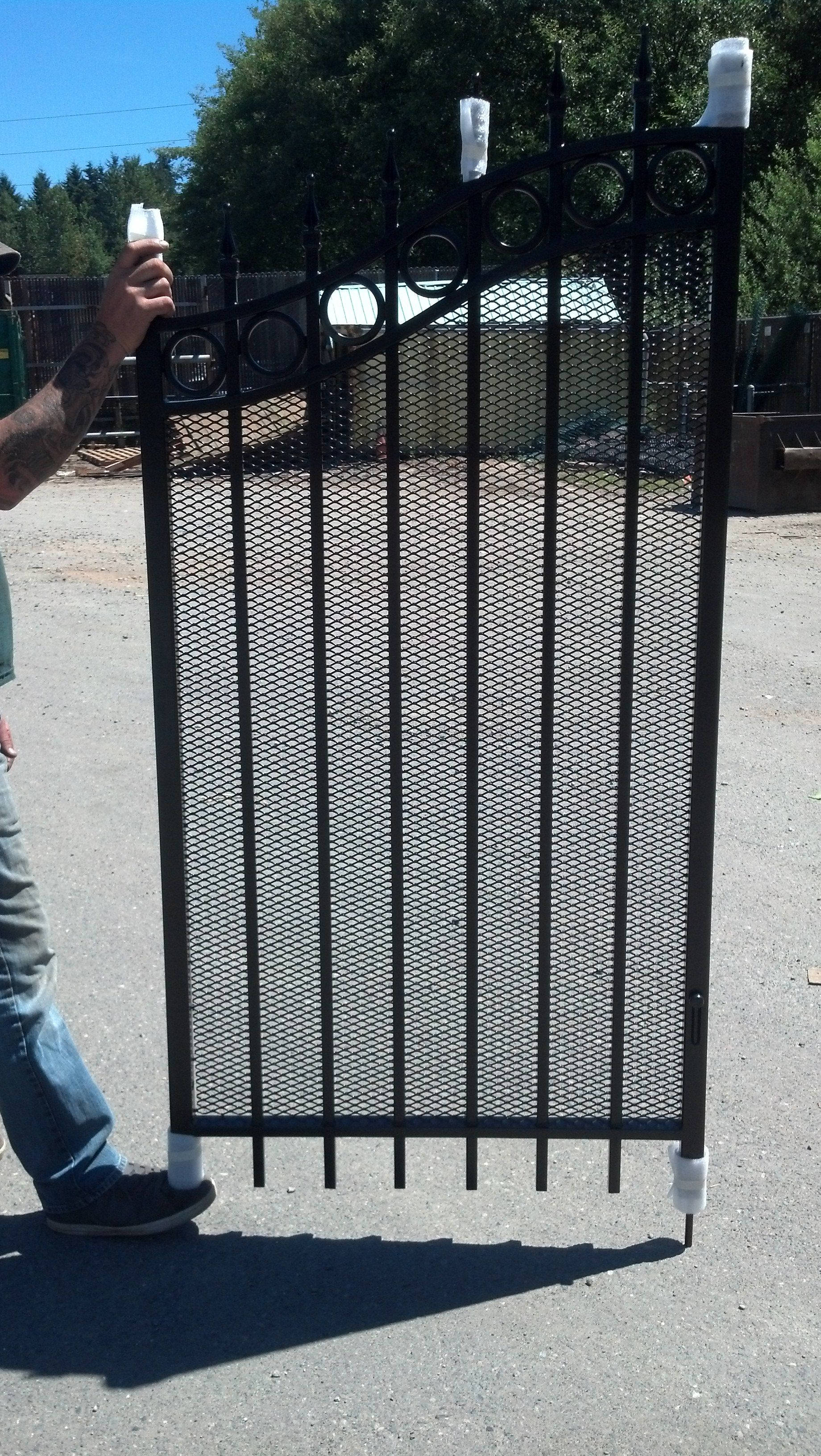 black ornamental iron gate, outdoors, bright sunny, 2K Phone Wallpaper