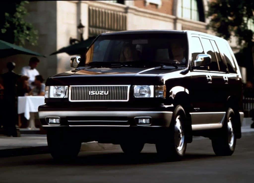 Isuzu Trooper, sleek black, sunlit city street, SD Desktop Wallpaper