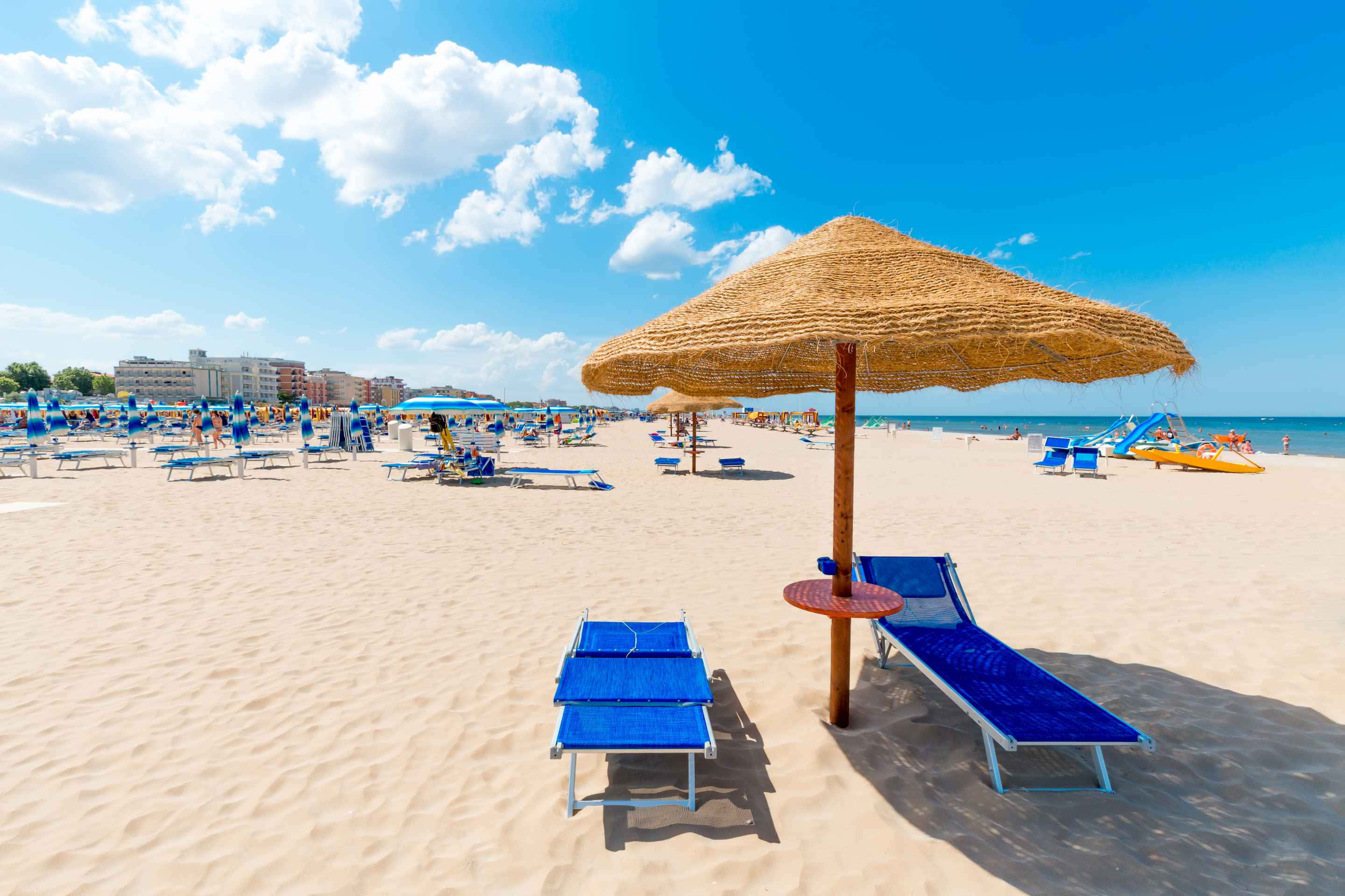 Italian beach, sunset, blue lounge chairs, 2K Desktop Wallpaper
