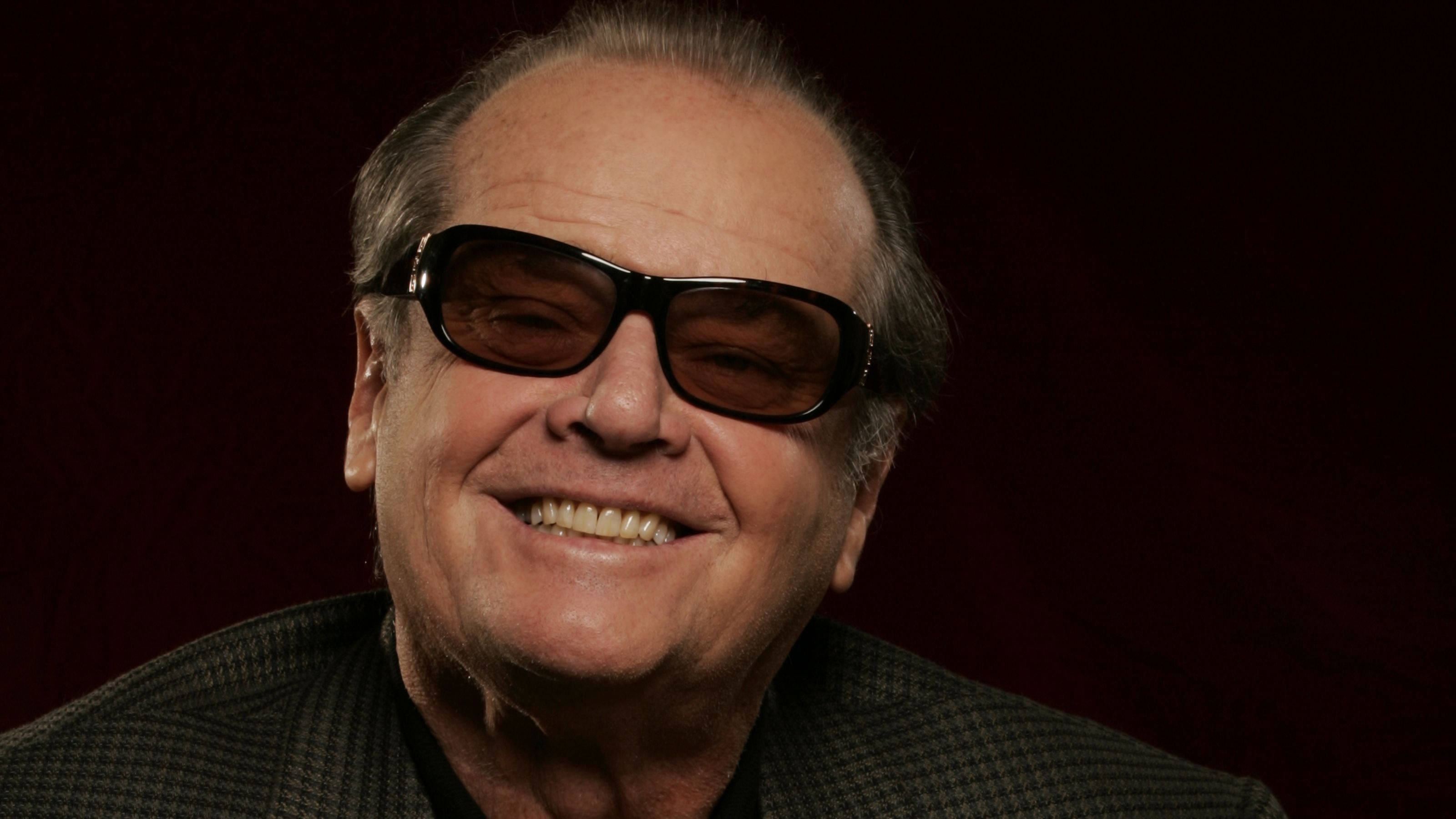 Jack Nicholson, dark sunglasses, deep red backdrop, 2K Desktop Wallpaper