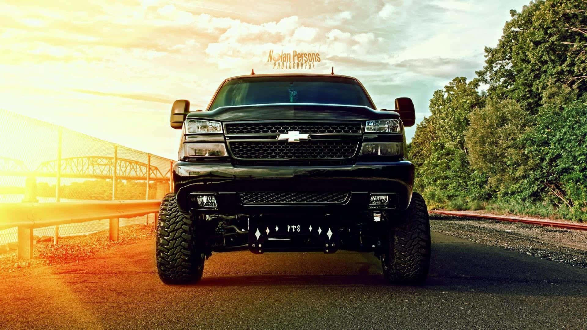 black, lifted Chevrolet truck, sunlit roadside, Full HD Desktop Wallpaper