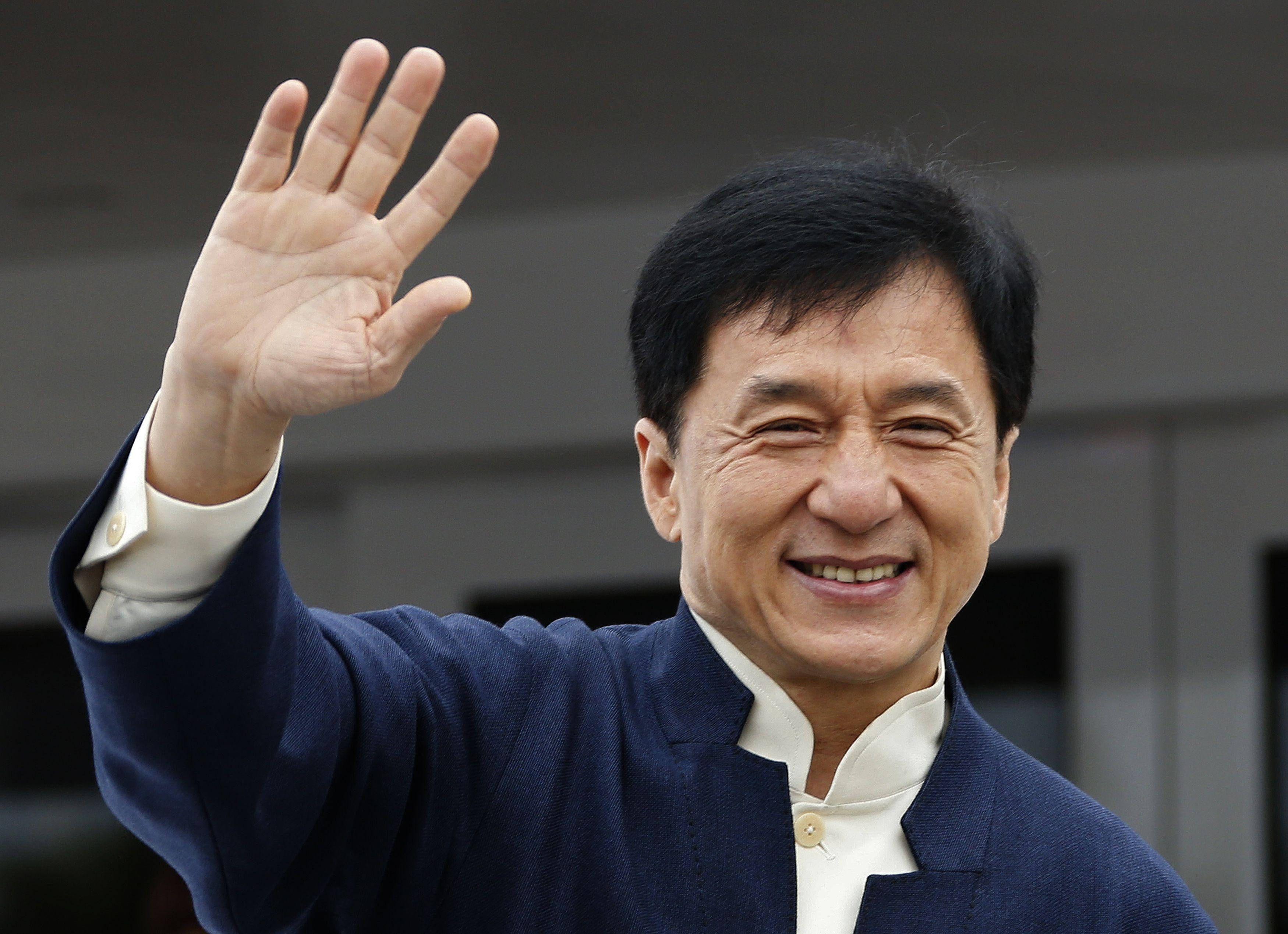 Jackie Chan, navy blue jacket, warm smile, 2K Desktop Wallpaper