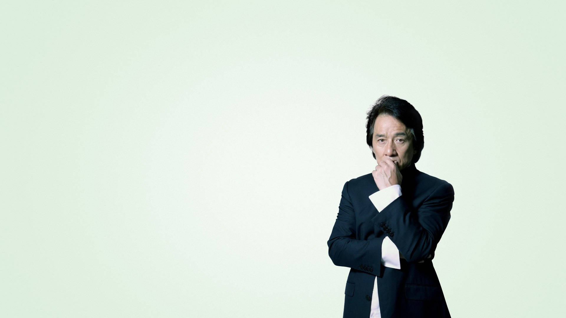 Jackie Chan, black suit, pale green background, Full HD Desktop Wallpaper