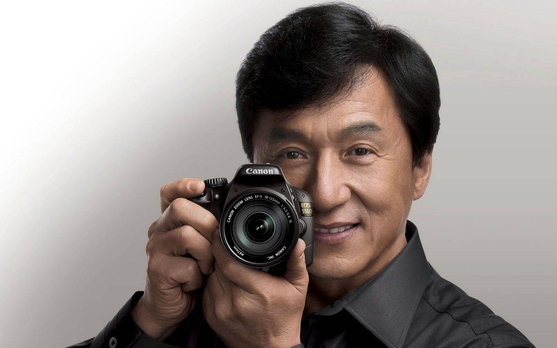 Jackie Chan, black Canon camera, plain light gray background, Full HD Desktop Wallpaper