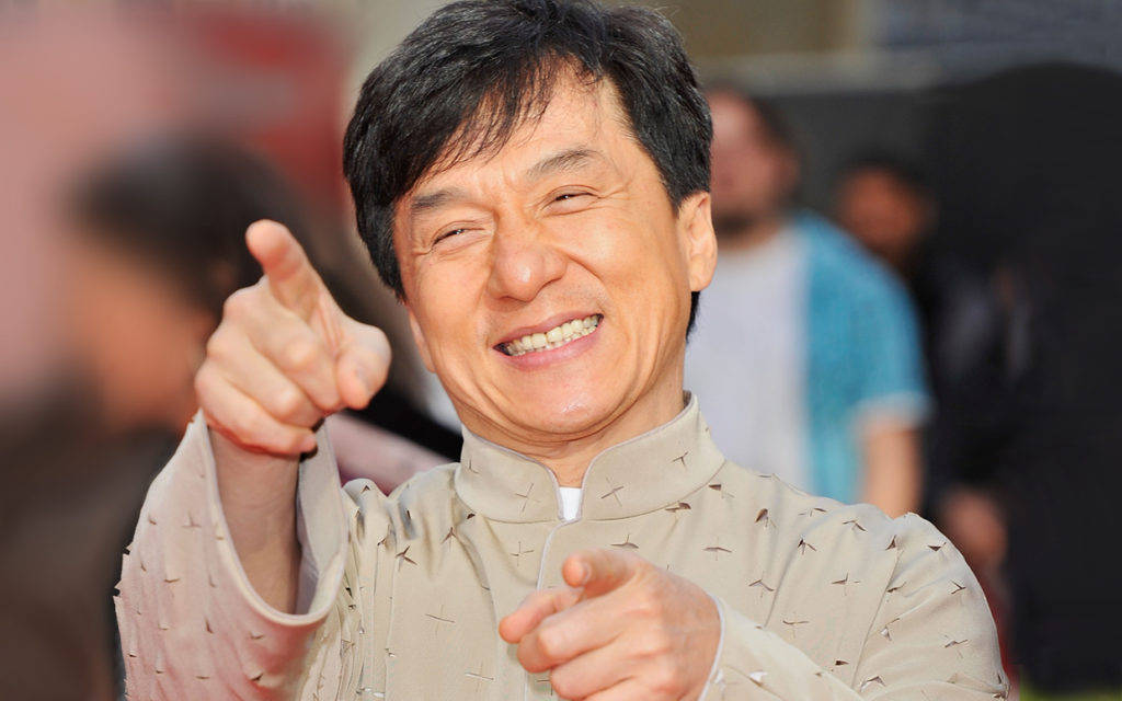 Jackie Chan, wide smile, pointing both fingers forward, SD Desktop Wallpaper
