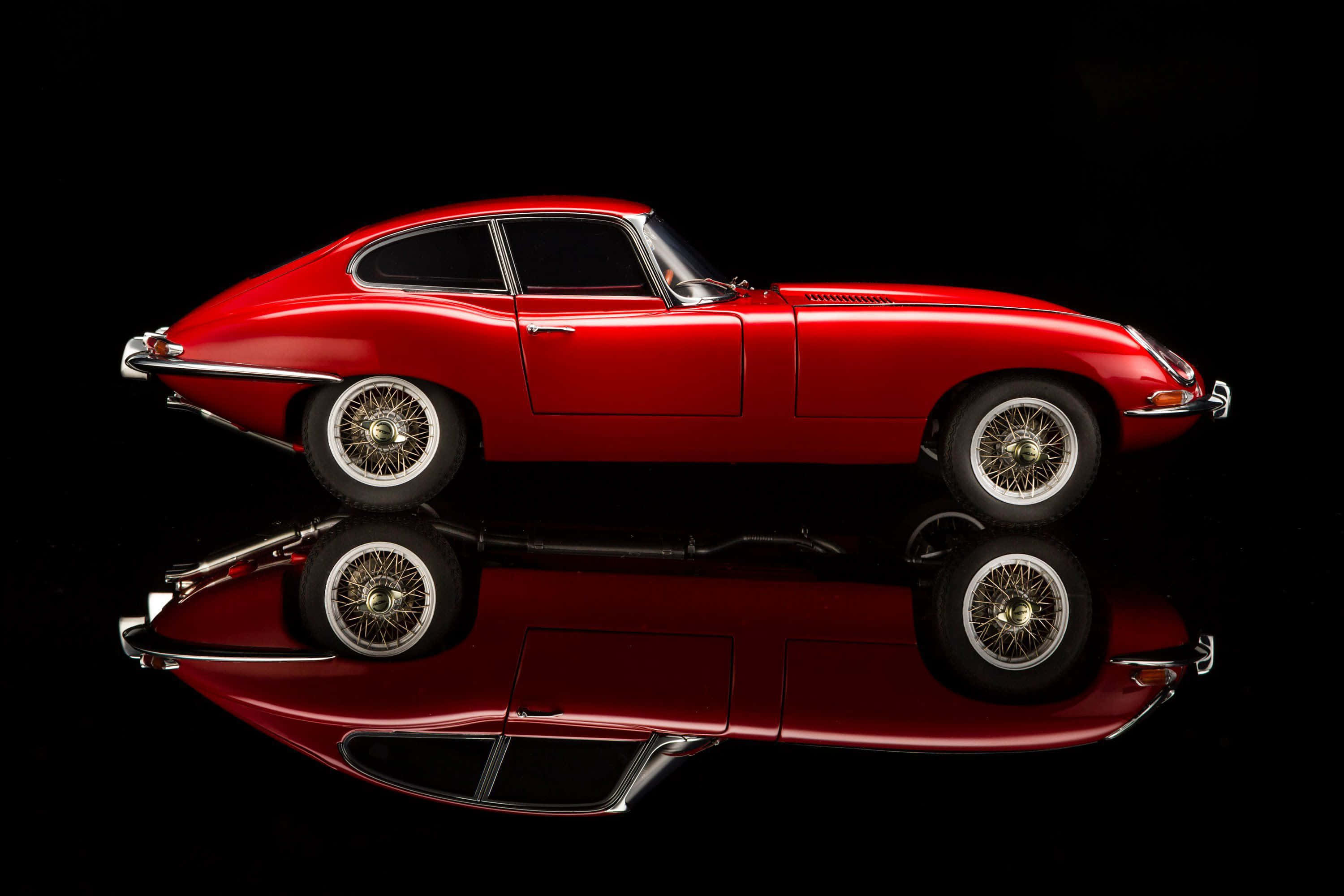 Jaguar E-type, glossy red, black reflective surface, 2K Desktop Wallpaper