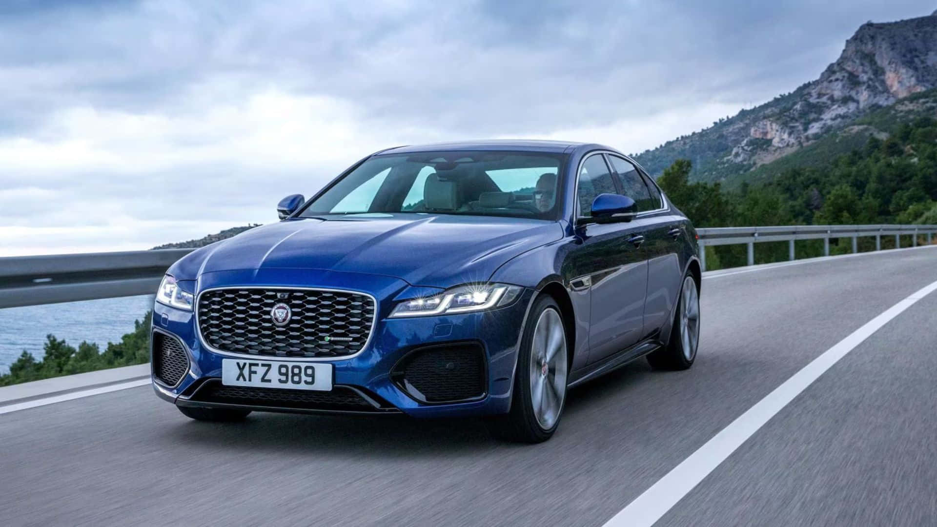 Jaguar XF, blue, coastal mountain road, Full HD Desktop Wallpaper