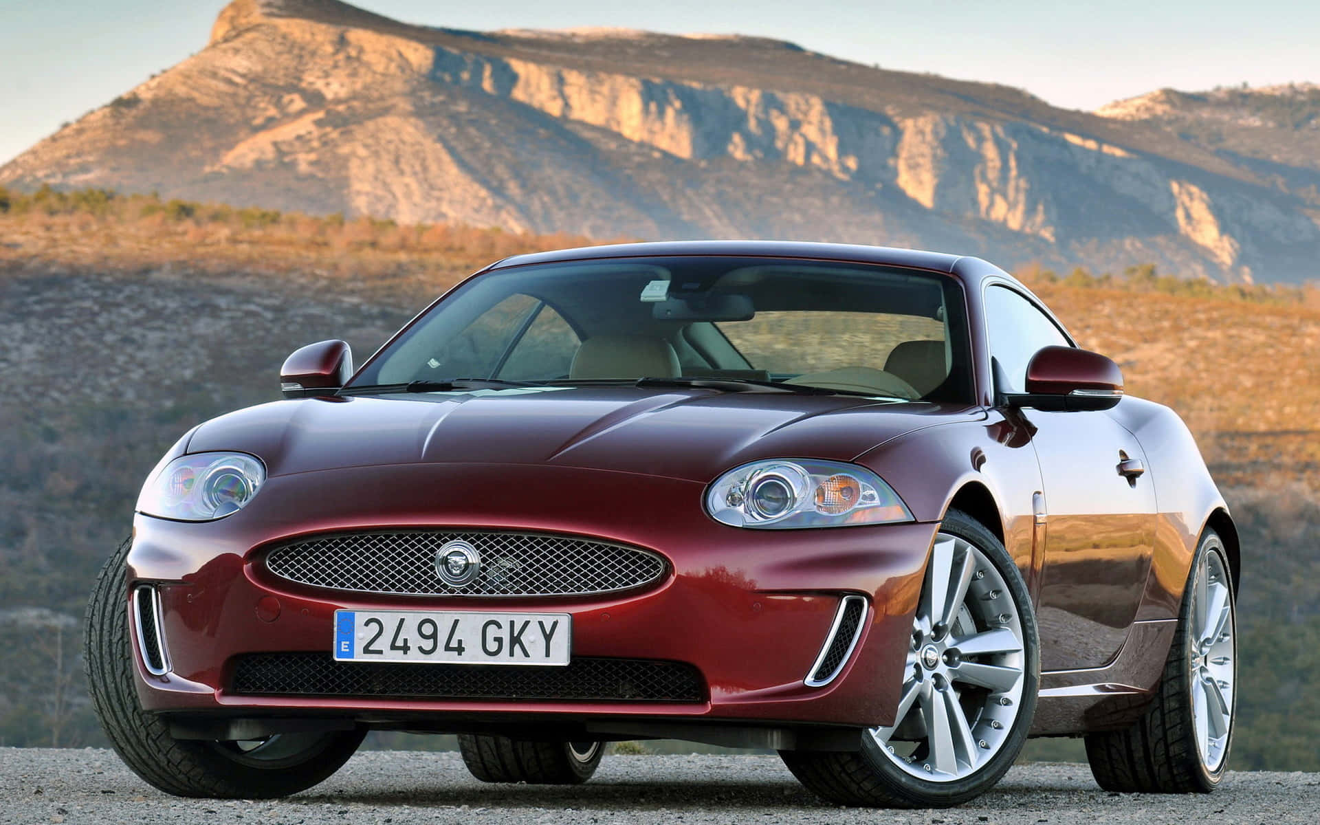 Jaguar XK, glossy red, gravel road, Full HD Desktop Wallpaper