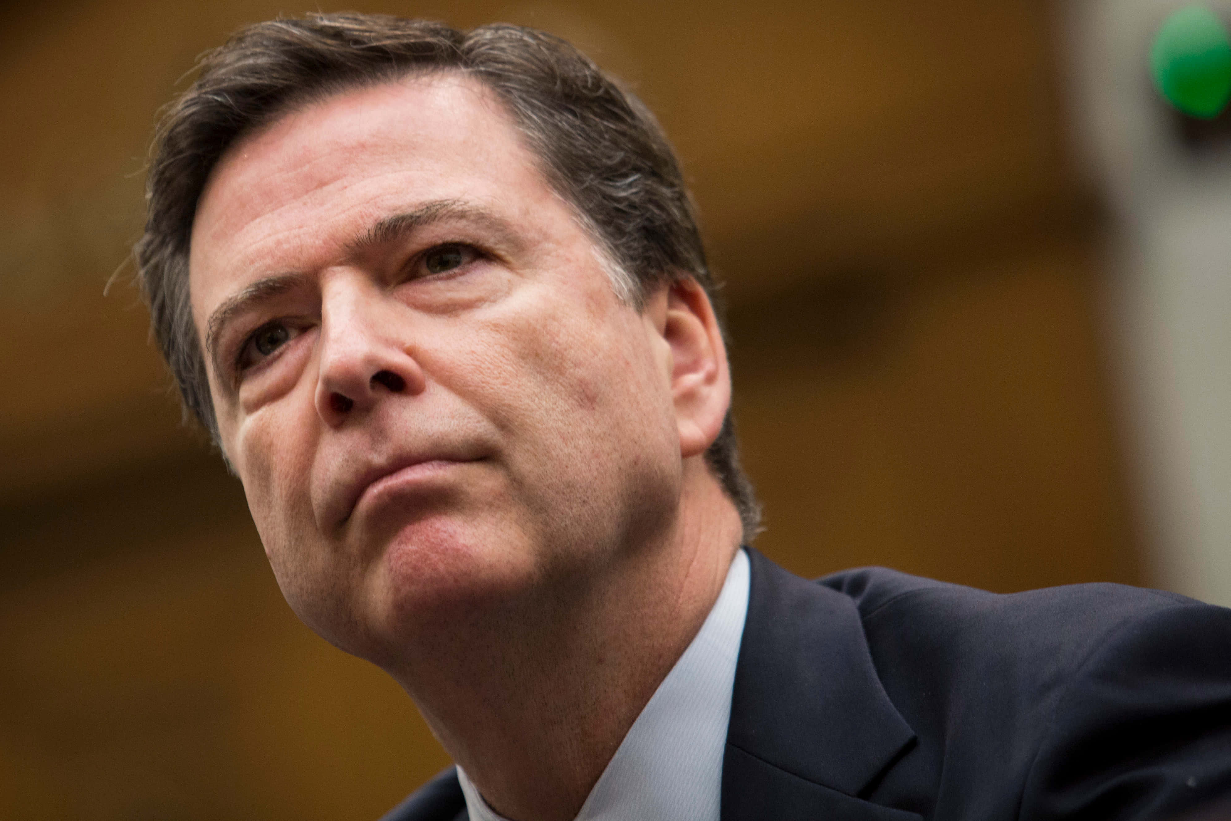 James Comey, dark suit, serious expression, 4K Desktop Wallpaper