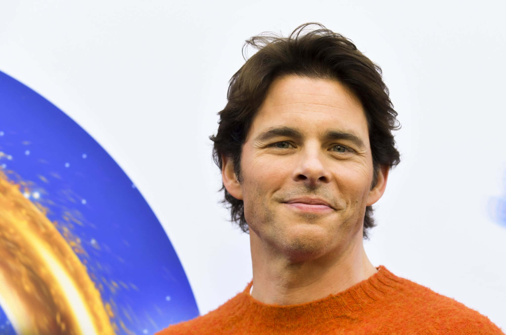 James Marsden, orange sweater, cosmic-themed backdrop, Full HD Desktop Wallpaper