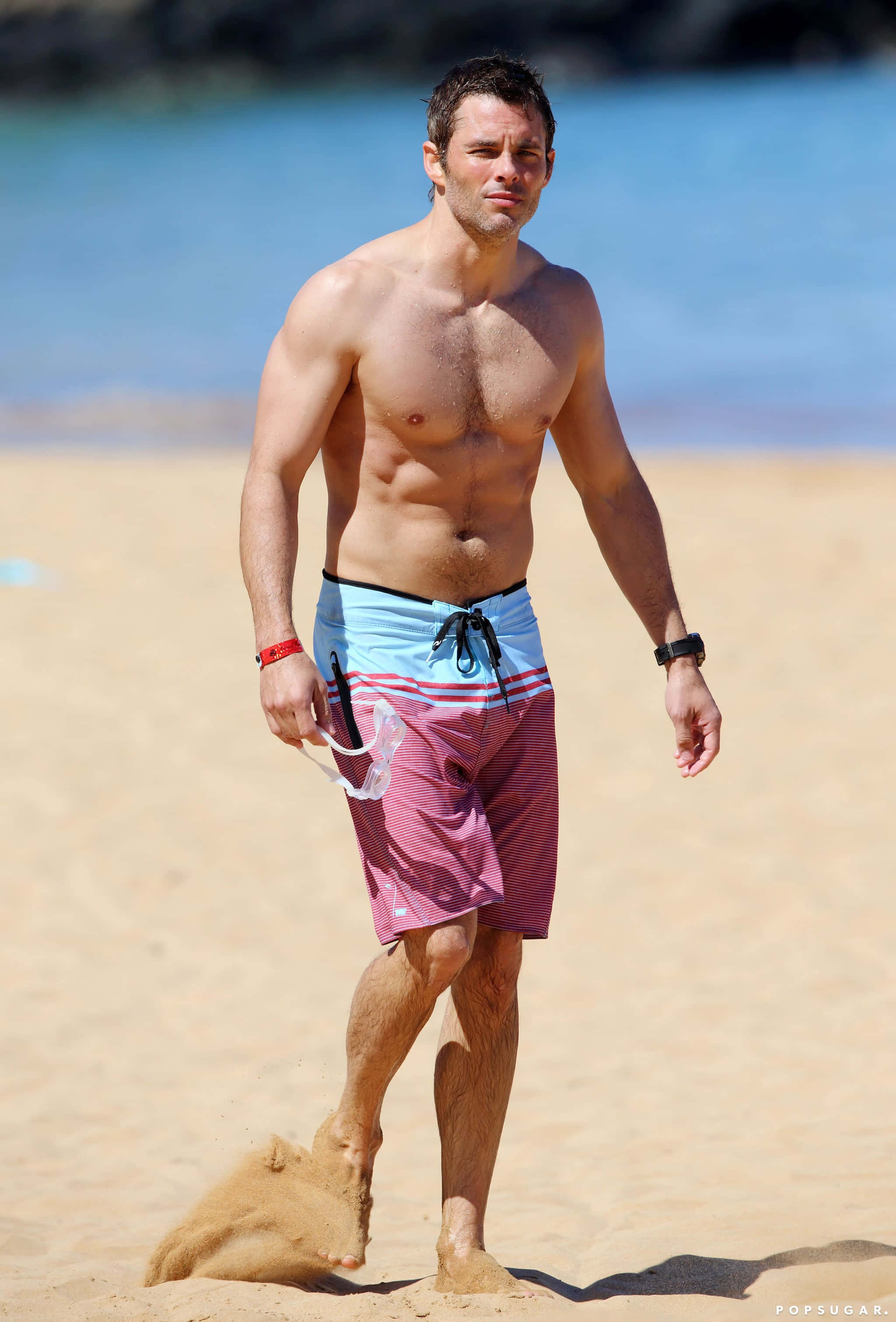 James Marsden, striped swim trunks, sunlit sandy beach, 2K Phone Wallpaper