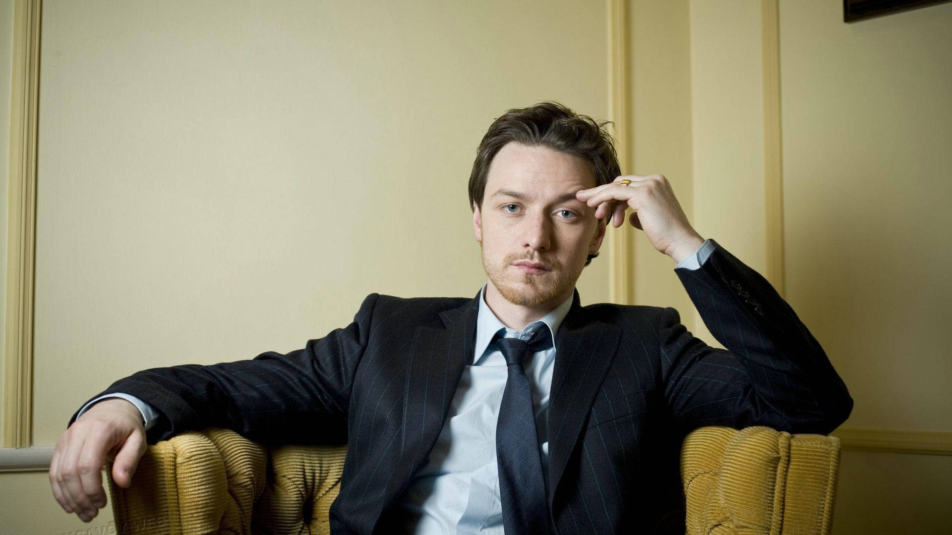 James McAvoy, dark pinstripe suit, mustard yellow armchair, Full HD Desktop Wallpaper