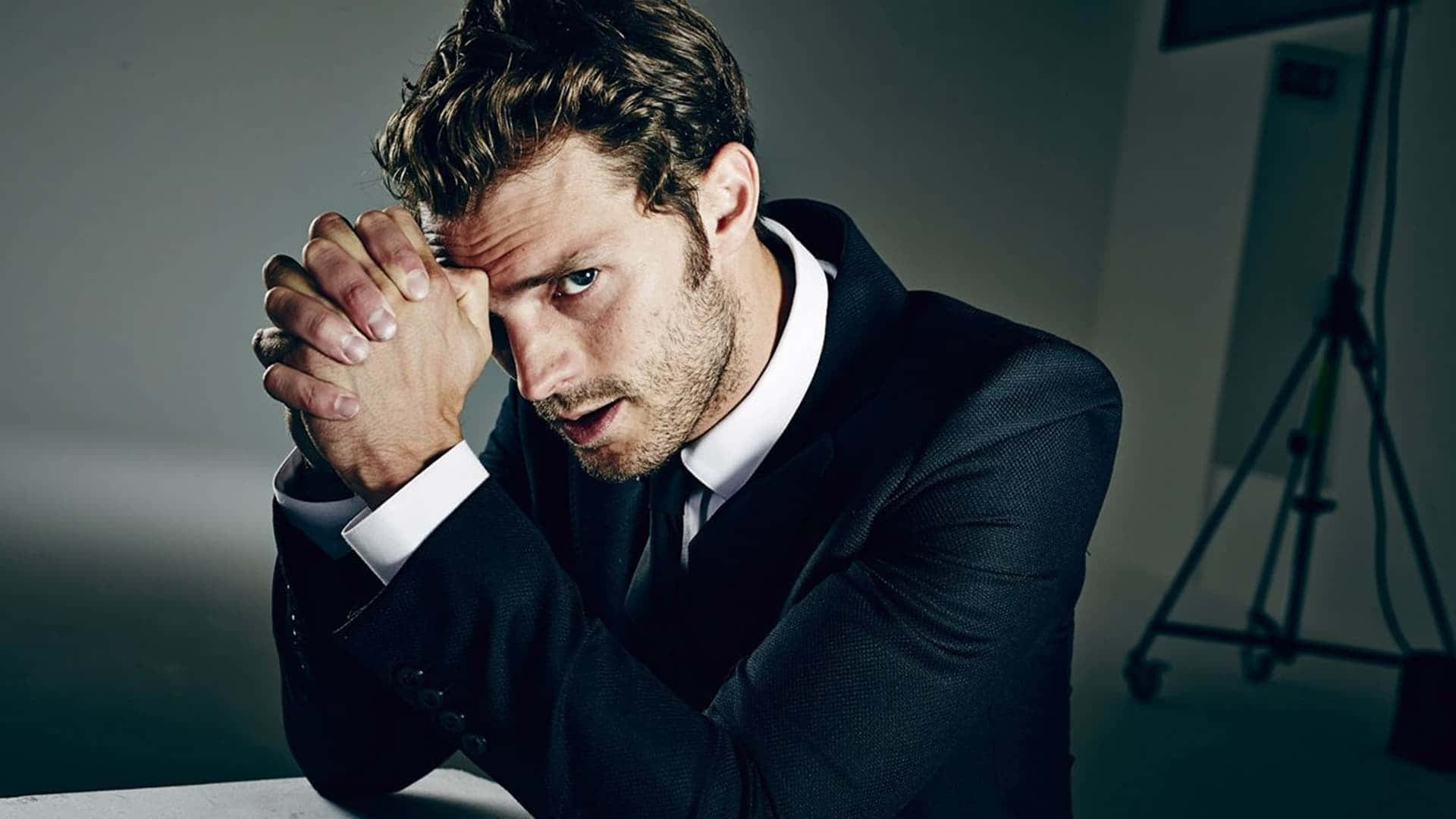 Jamie Dornan, dark suit, dimly lit studio, Full HD Desktop Wallpaper