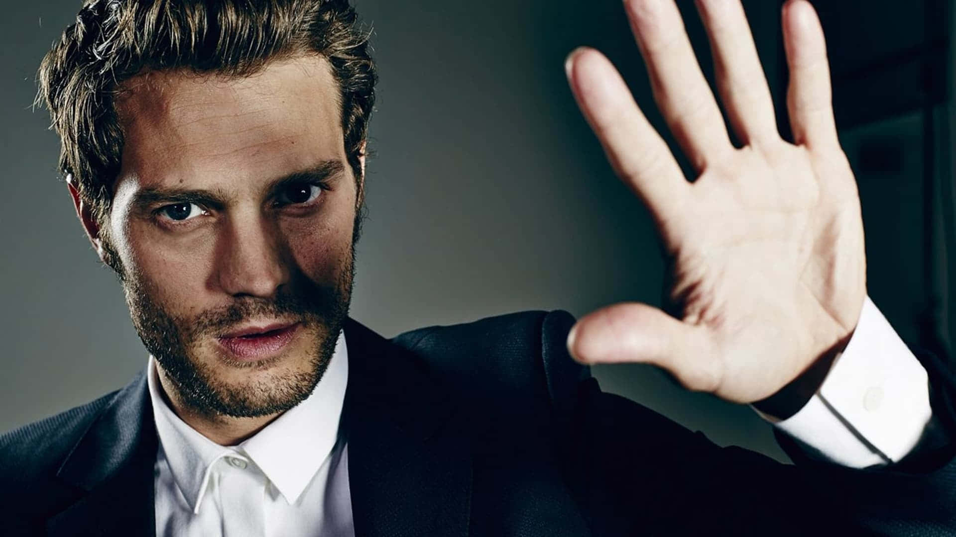 Jamie Dornan, dark suit, stop gesture, Full HD Desktop Wallpaper