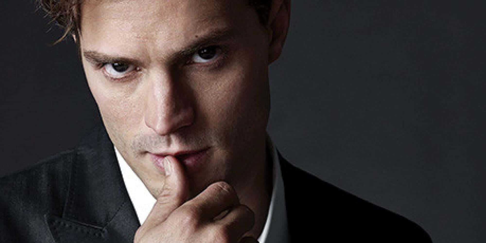 Jamie Dornan, dark suit, finger to lips, Full HD Desktop Wallpaper