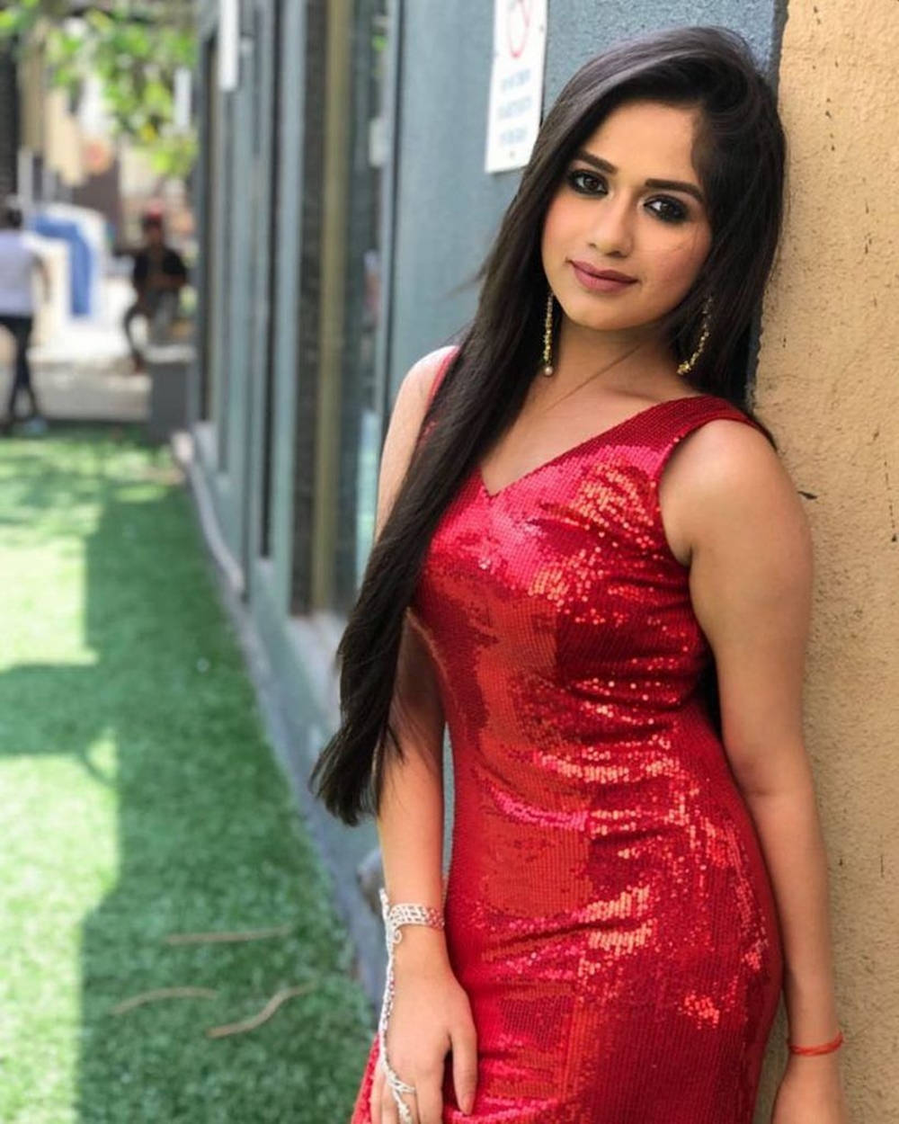 Jannat Zubair, shimmering red sequined dress, sunny urban sidewalk, SD Phone Wallpaper