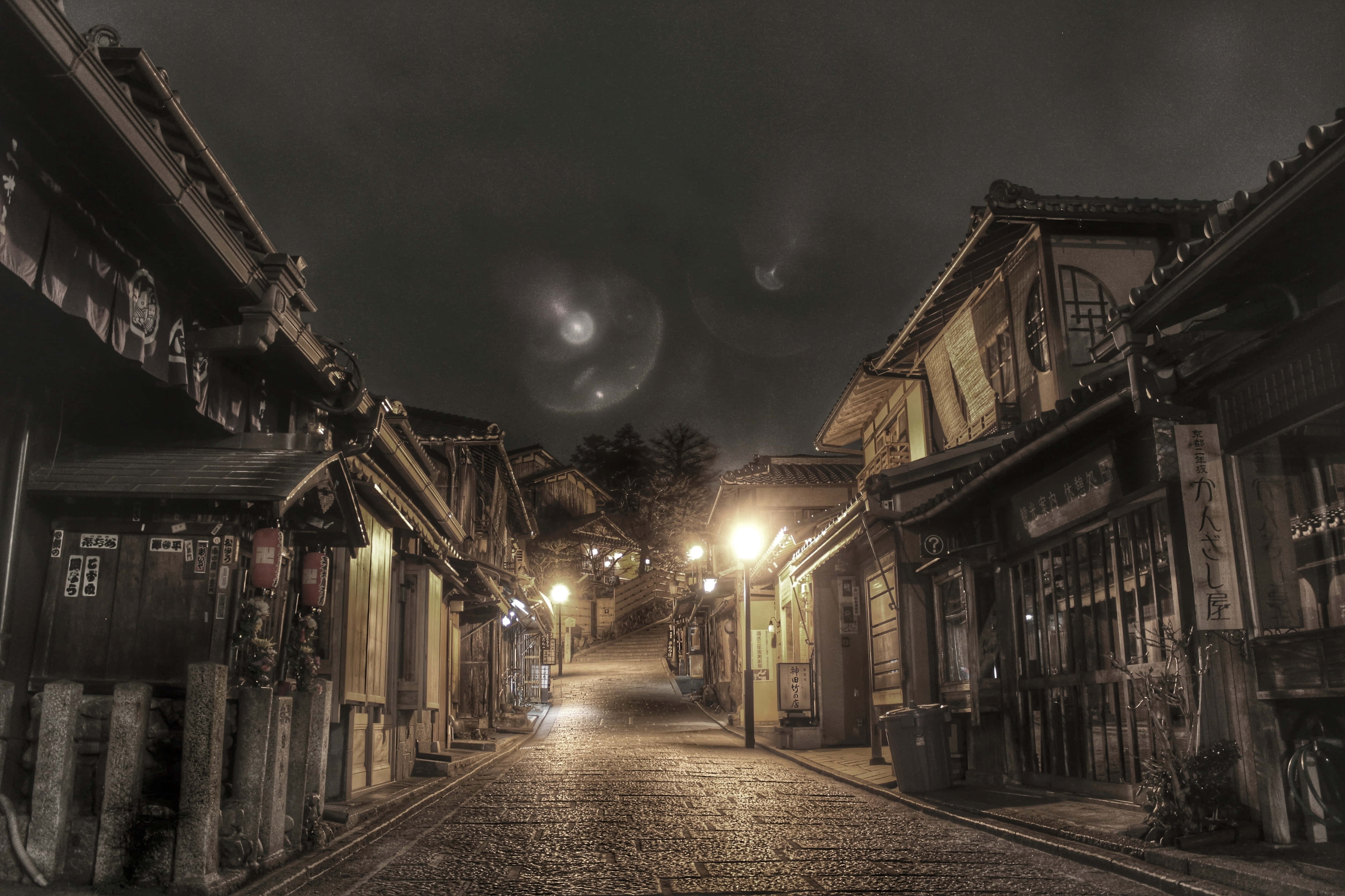 traditional wooden buildings, narrow cobblestone street, dark sky, 4K Desktop Wallpaper