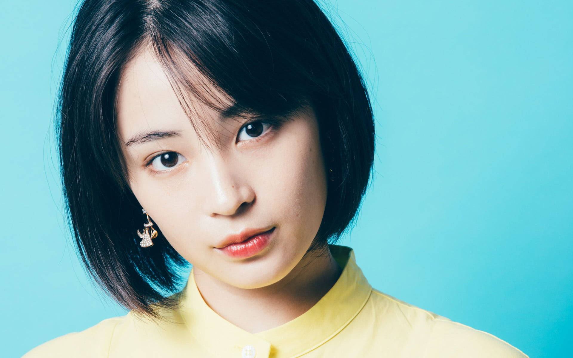 short black hair, yellow shirt, solid blue background, Full HD Desktop Wallpaper