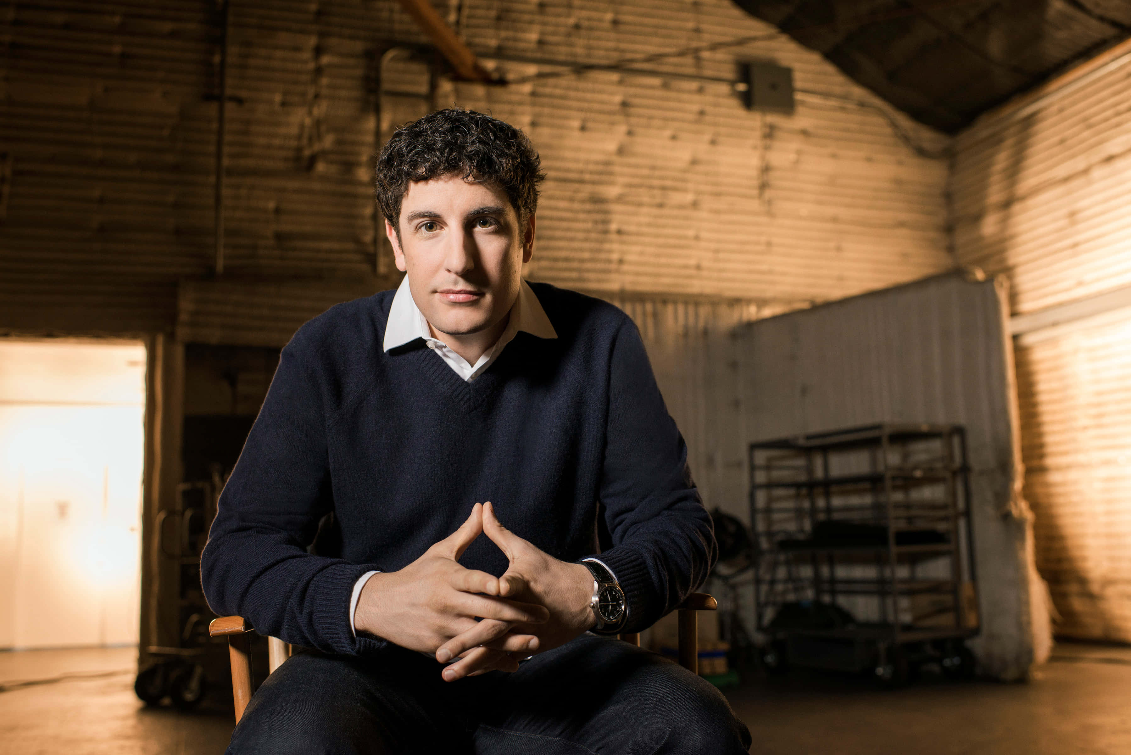 Jason Biggs, navy sweater, wooden chair, 2K Desktop Wallpaper
