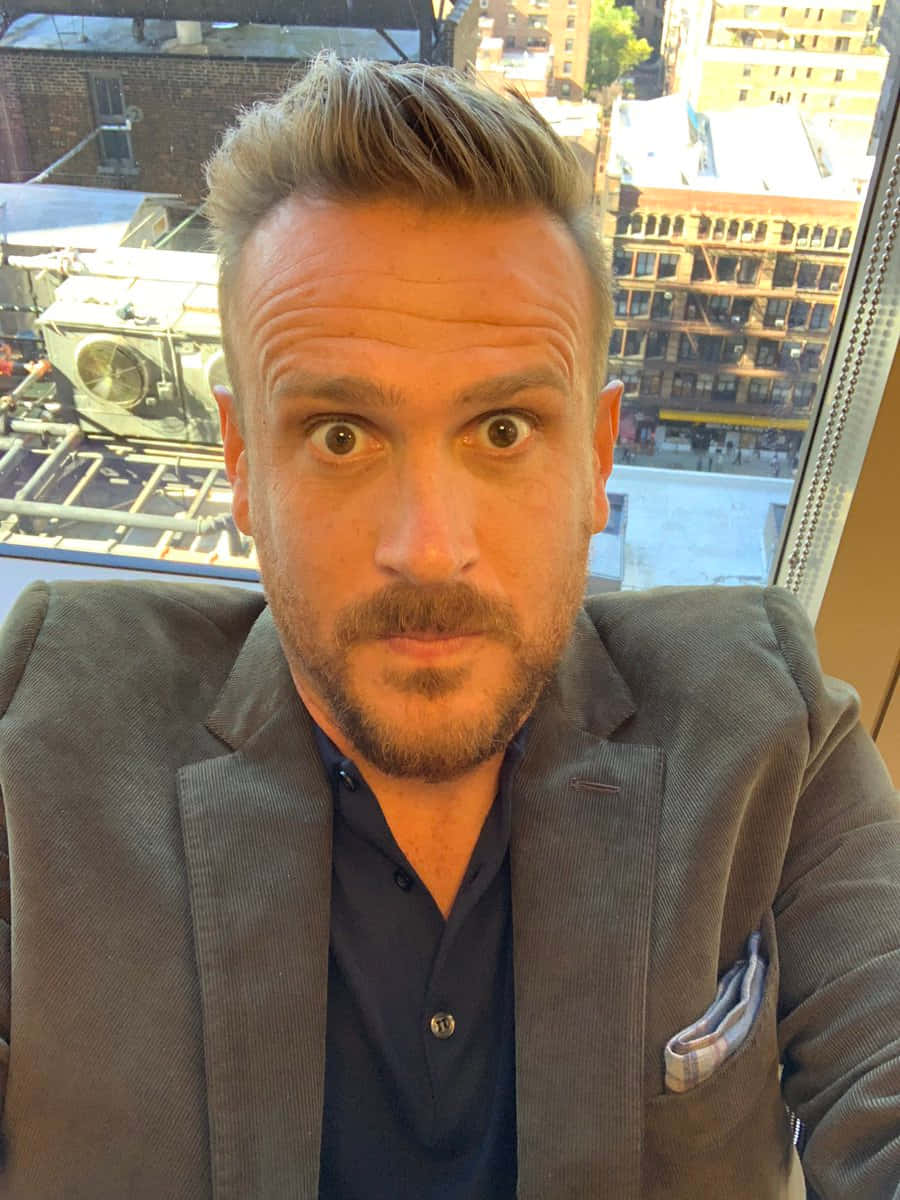 Jason Segel, smiling portrait, window, SD Phone Wallpaper