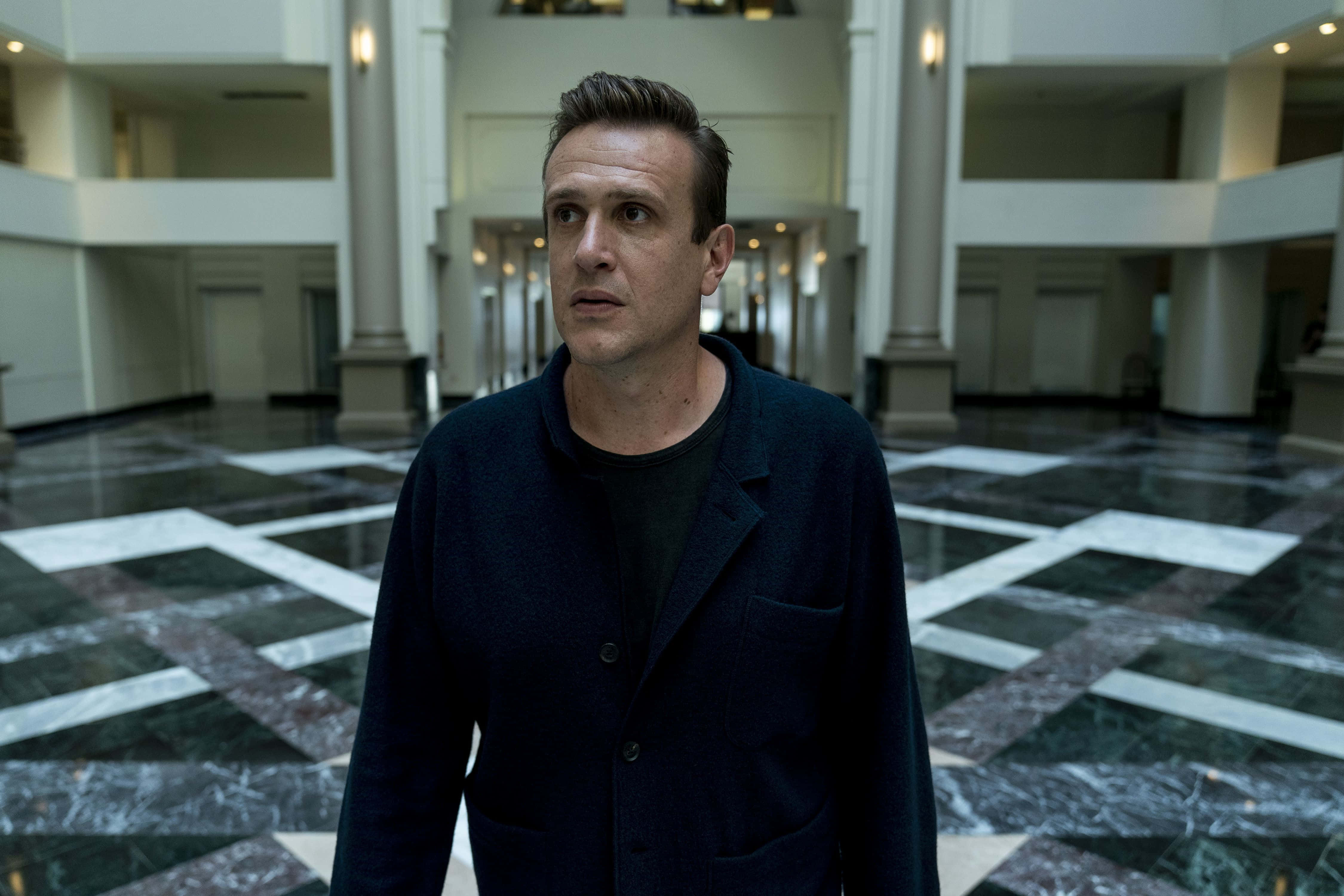 Jason Segel, dark coat, marble-floored lobby, 4K Desktop Wallpaper