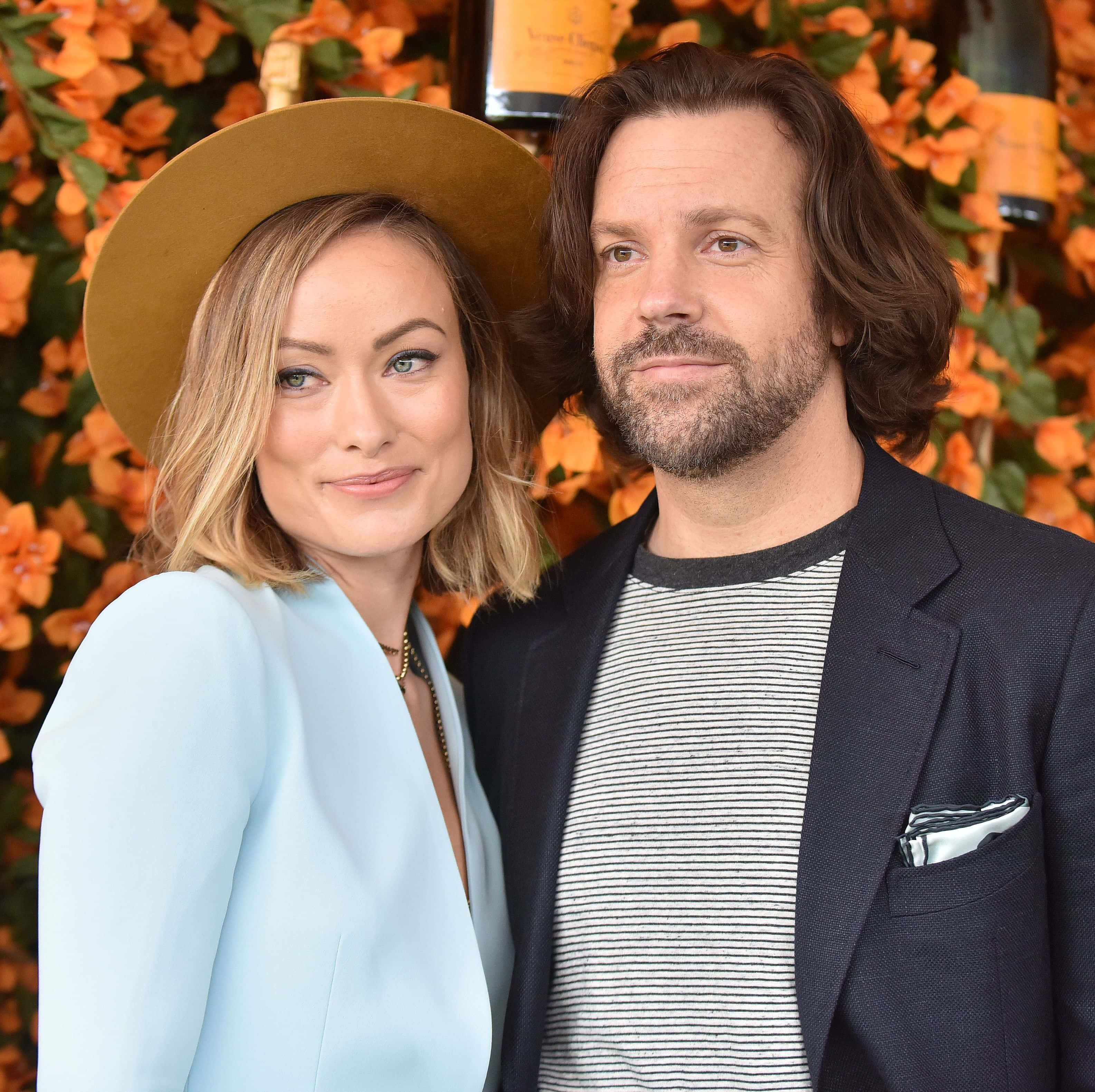 Jason Sudeikis, vibrant orange floral backdrop, champagne bottles, 2K Desktop Wallpaper