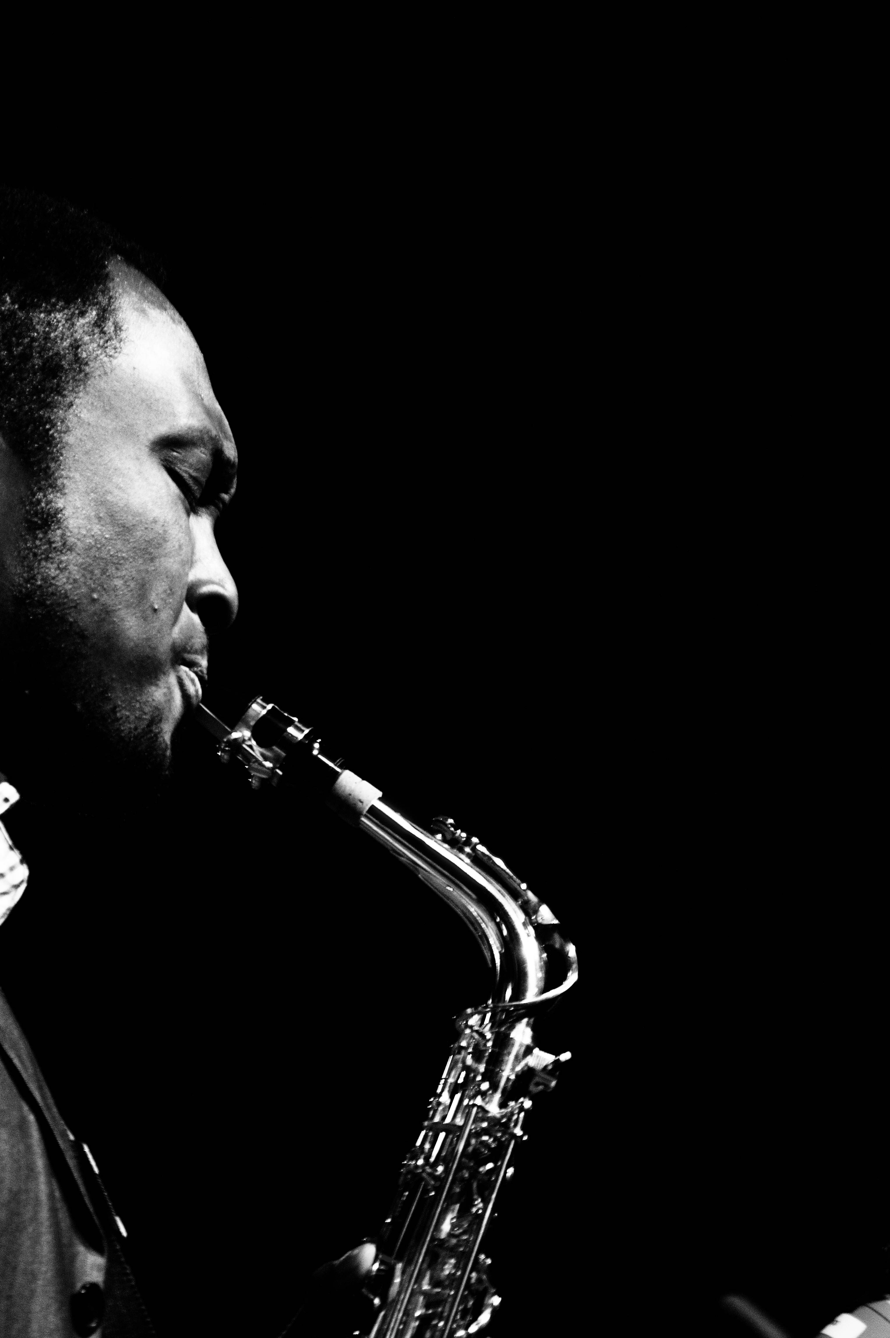 jazz saxophone player, black and white, dramatic lighting, 4K Phone Wallpaper