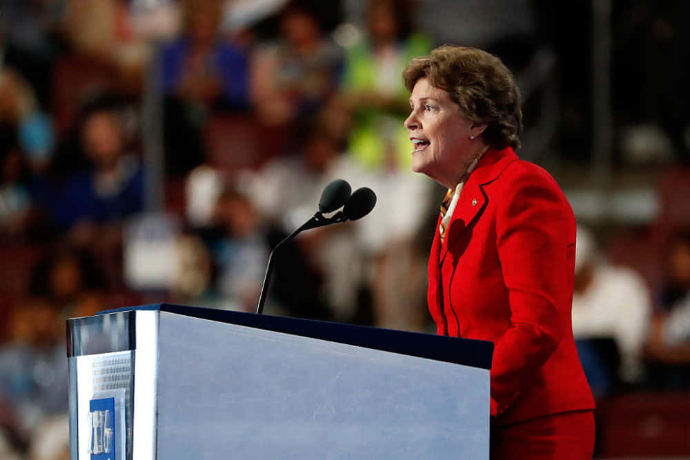 Jeanne Shaheen, red suit, podium, SD Desktop Wallpaper