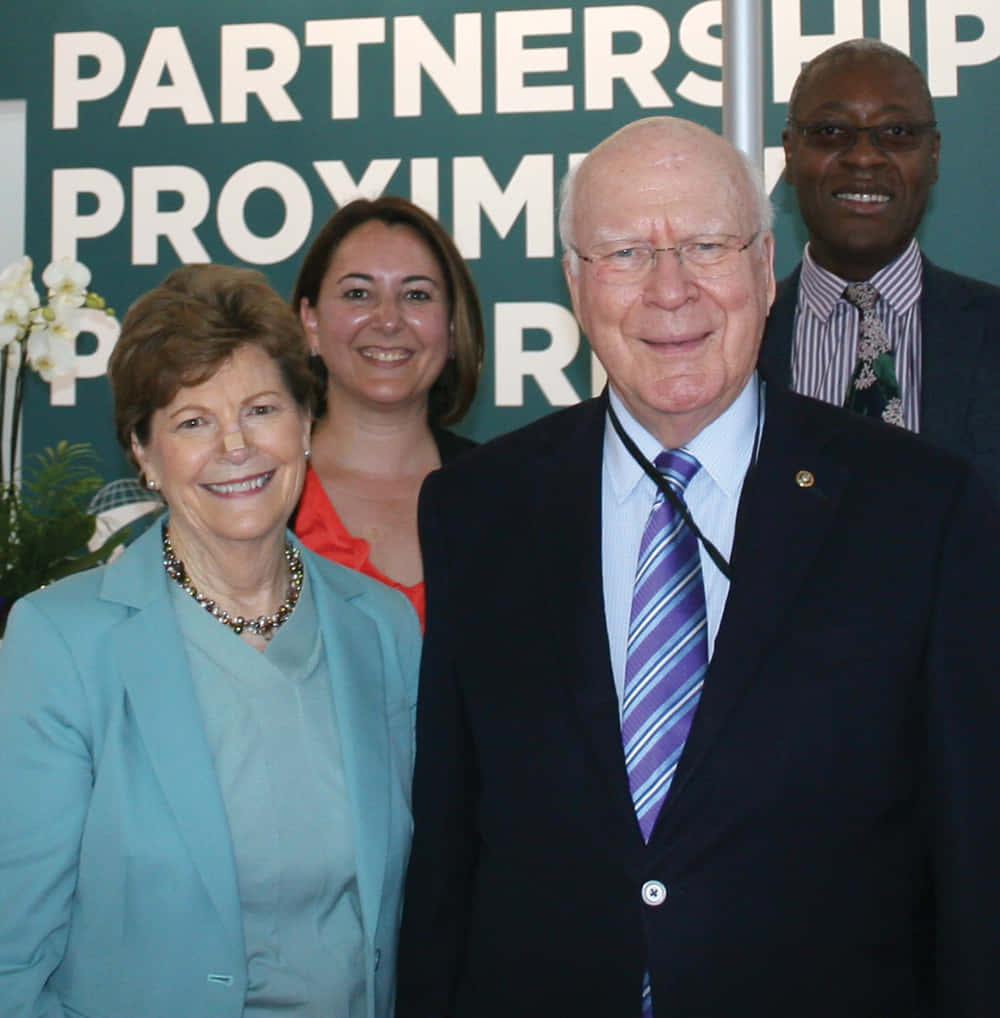 Jeanne Shaheen, PARTNERSHIP PROXIMITY, green backdrop, SD Phone Wallpaper