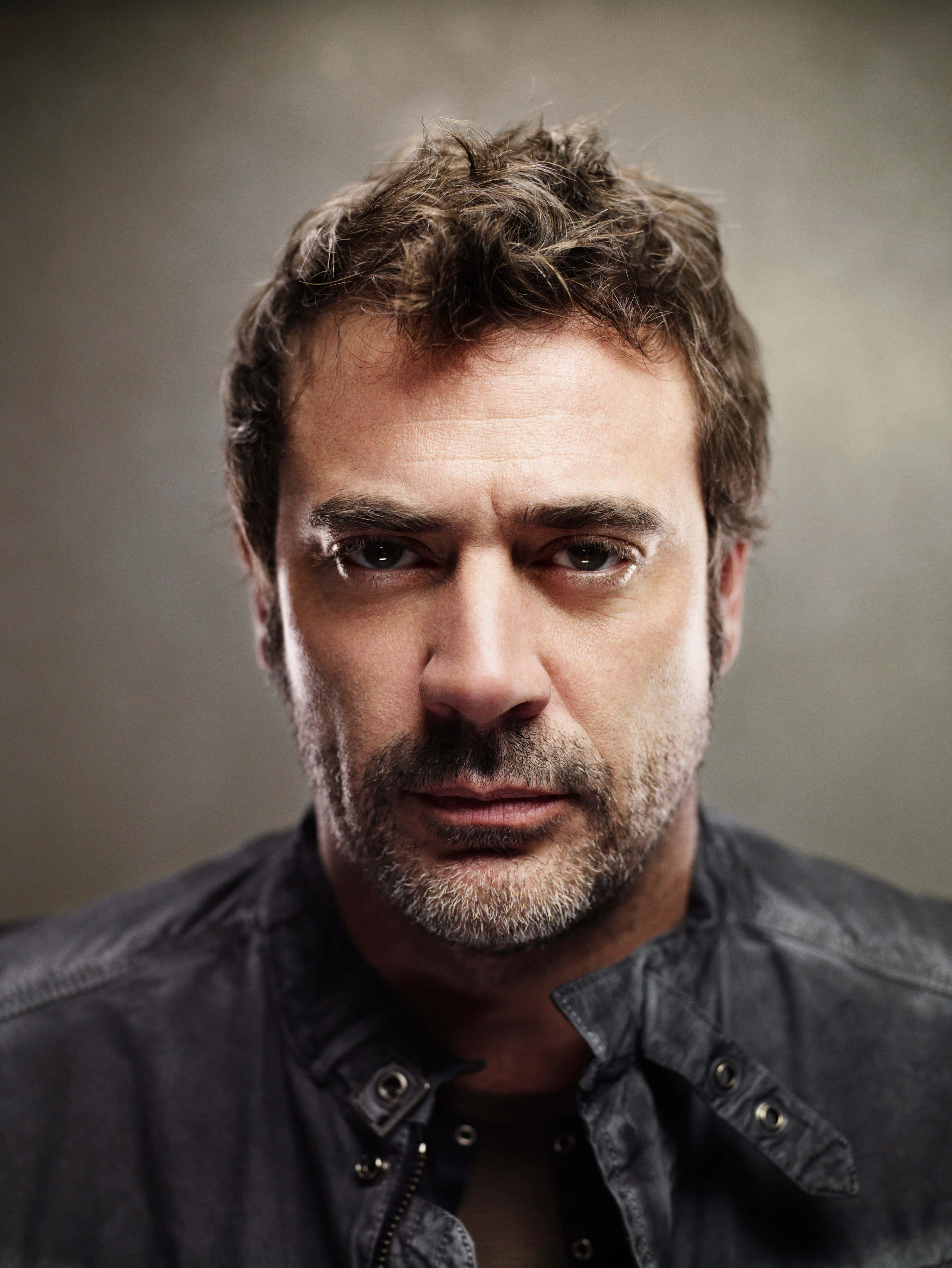 Jeffrey Dean Morgan, dark jacket, muted gray background, 2K Phone Wallpaper