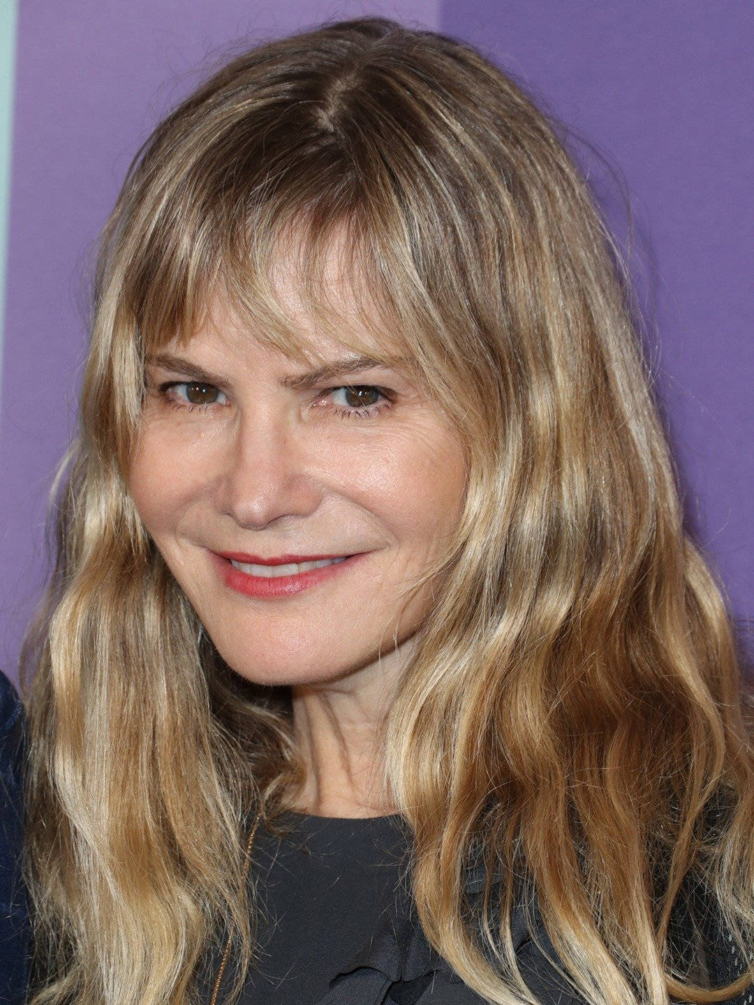 Jennifer Jason Leigh, wavy blonde hair, warm smile, HD Phone Wallpaper