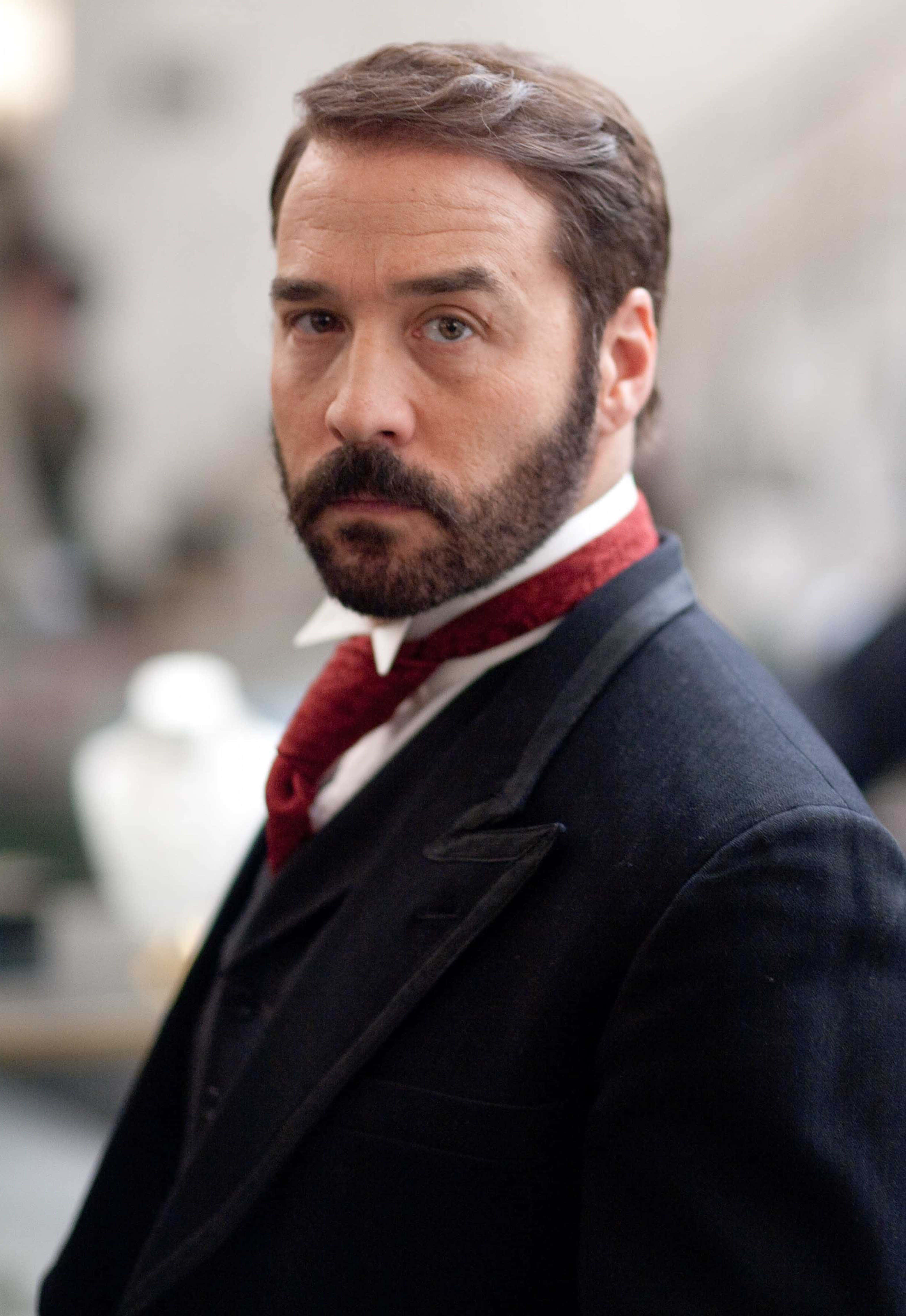 Jeremy Piven, red bow tie, dimly lit vintage setting, 4K Phone Wallpaper