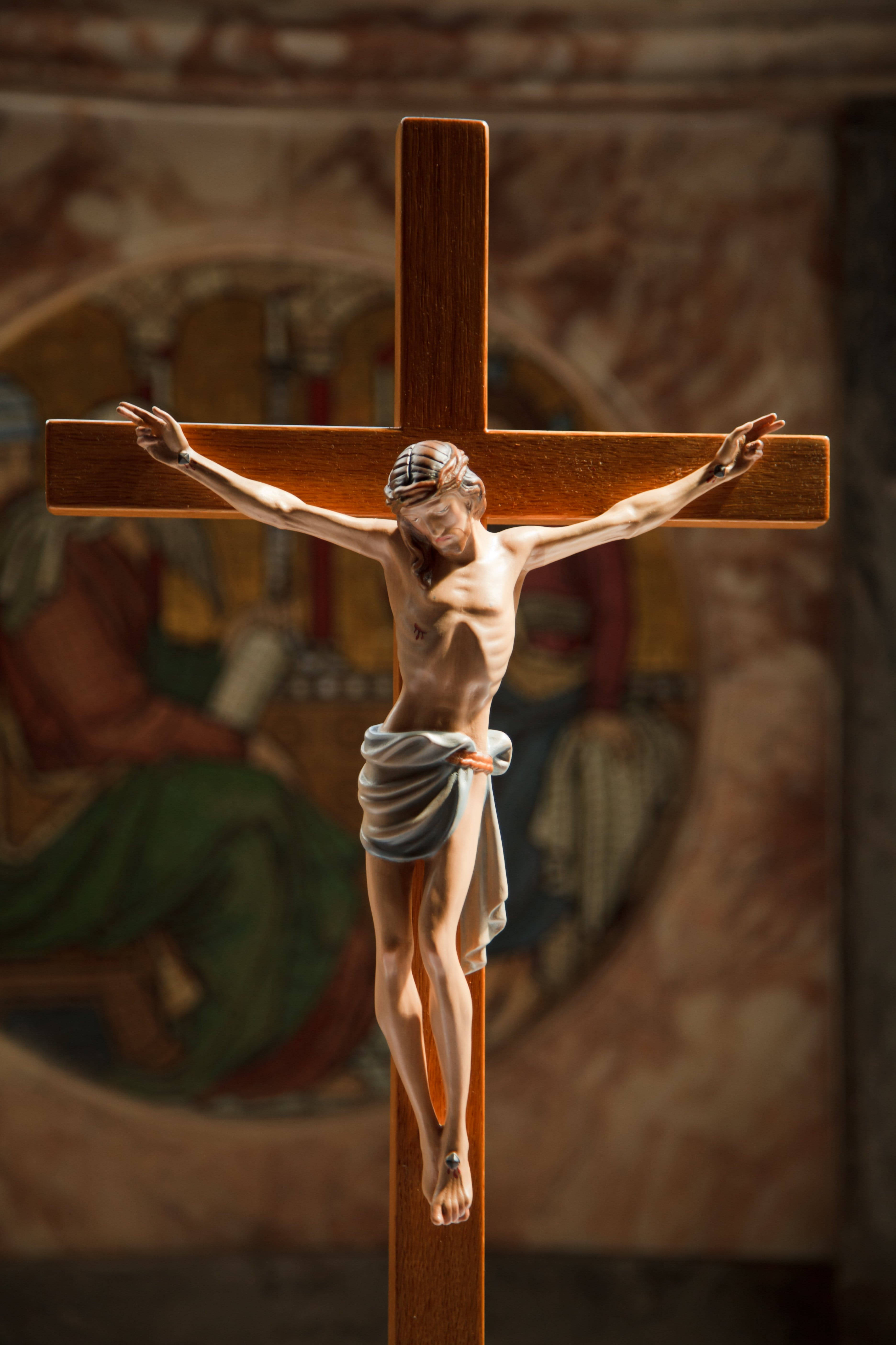 Jesus Christ, wooden crucifix, softly lit church, 5K Phone Wallpaper