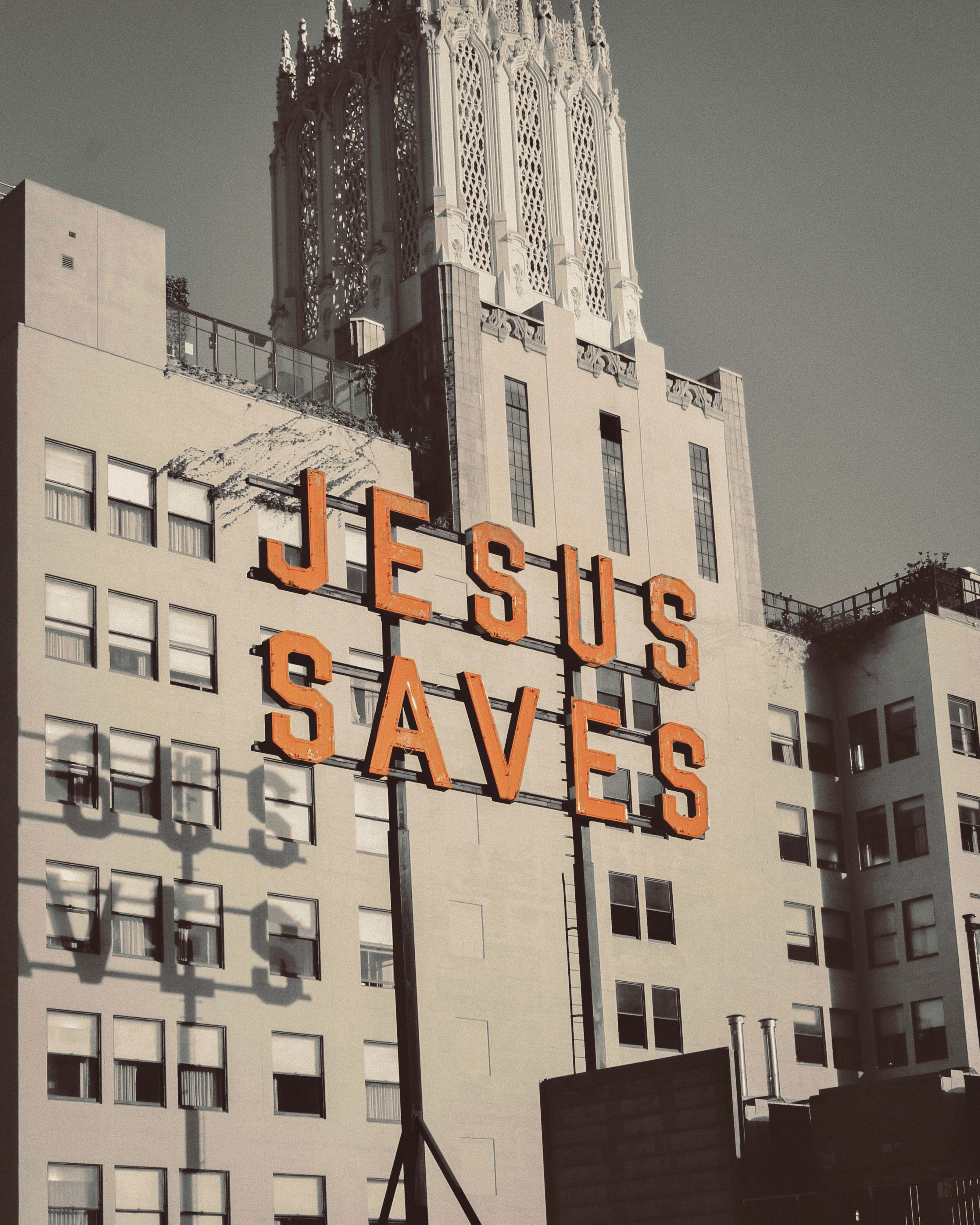 JESUS SAVES, Gothic-style tower, stark urban building, 4K Phone Wallpaper