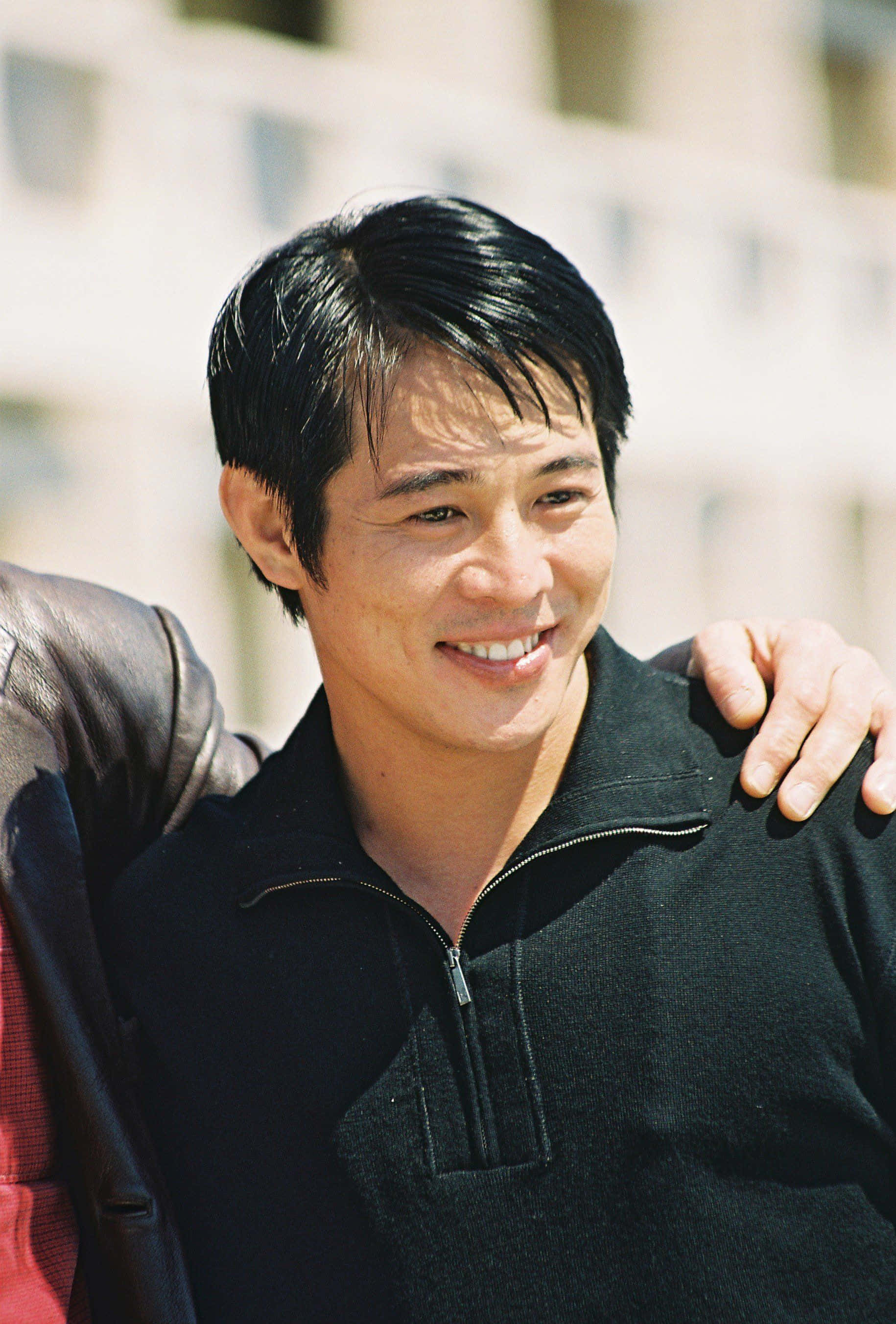 Jet Li, black zip-neck sweater, outdoors, 2K Phone Wallpaper